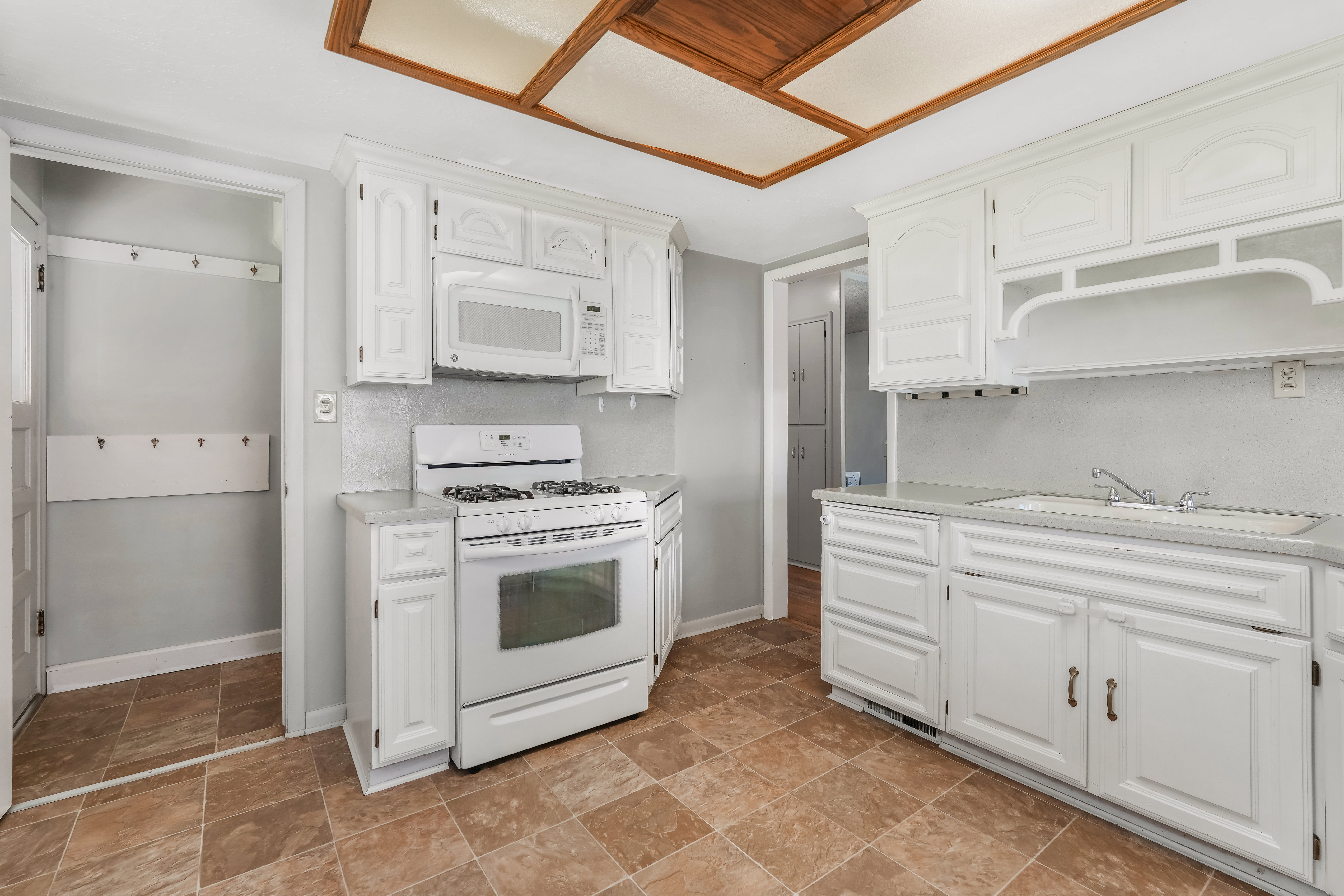 Kitchen featuring white cabinetry, white appliances, and a wood-finish coffered ceiling
