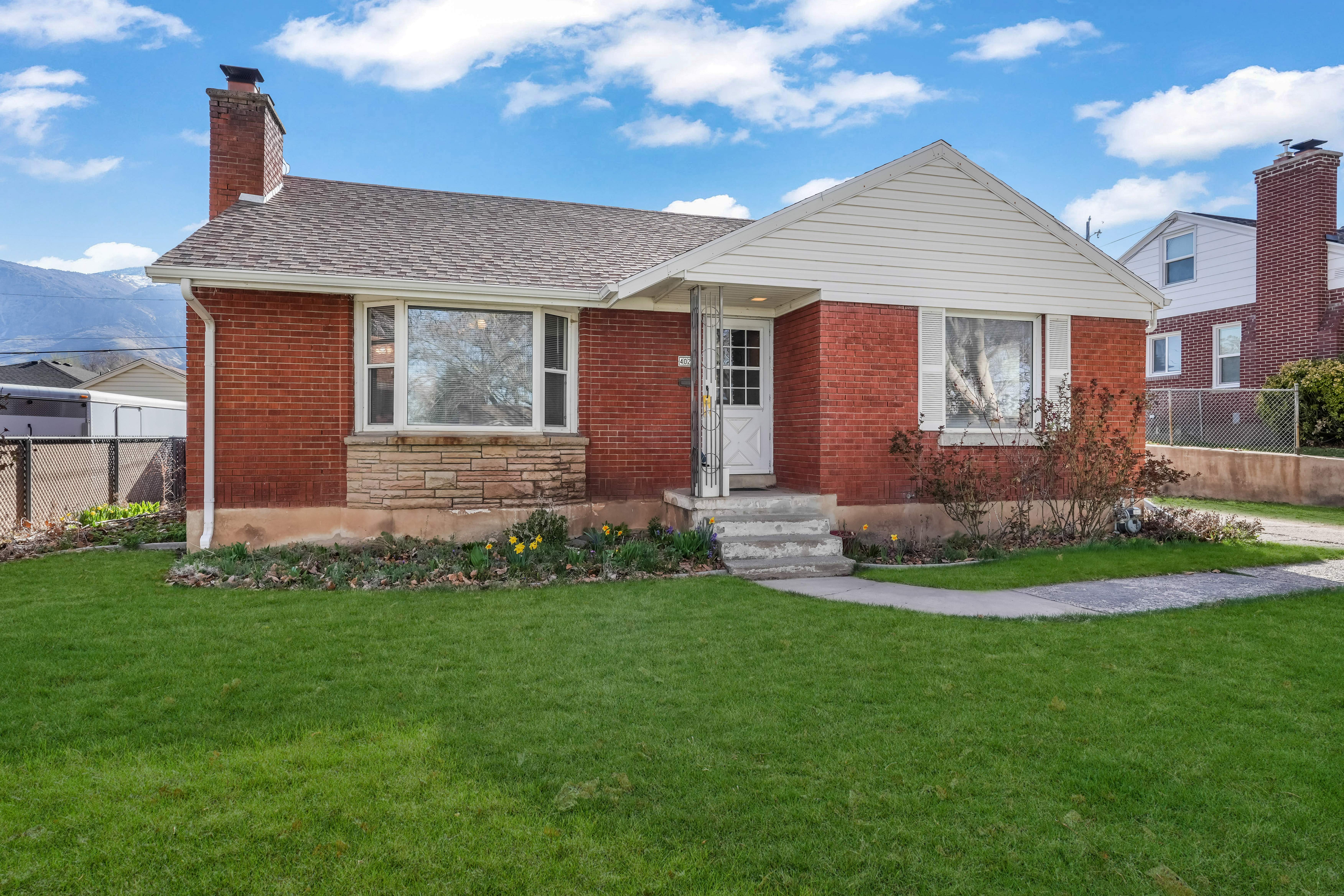 Brick exterior with a stone accent facade and white siding gable