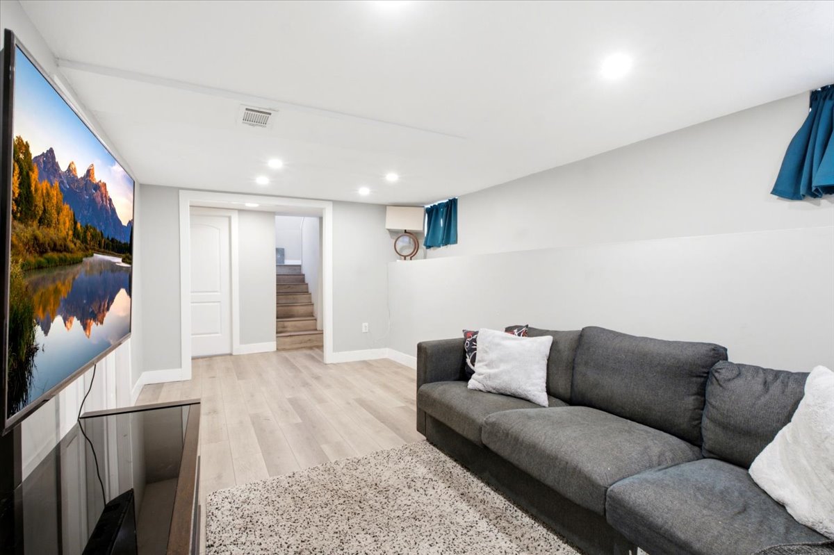 Bright & inviting finished basement with surprisingly tall ceilings.