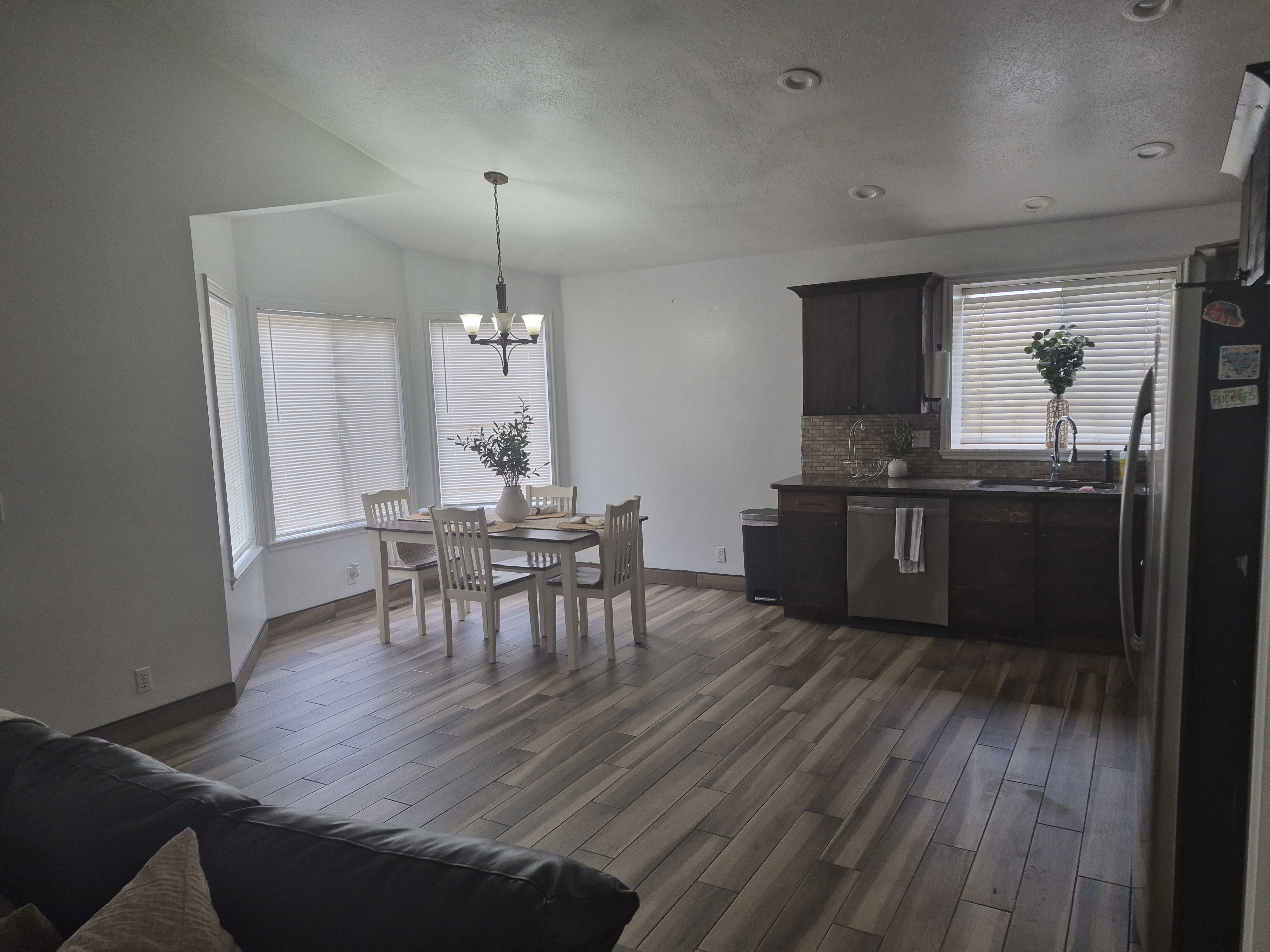 Open-concept living space featuring wood-finish flooring throughout