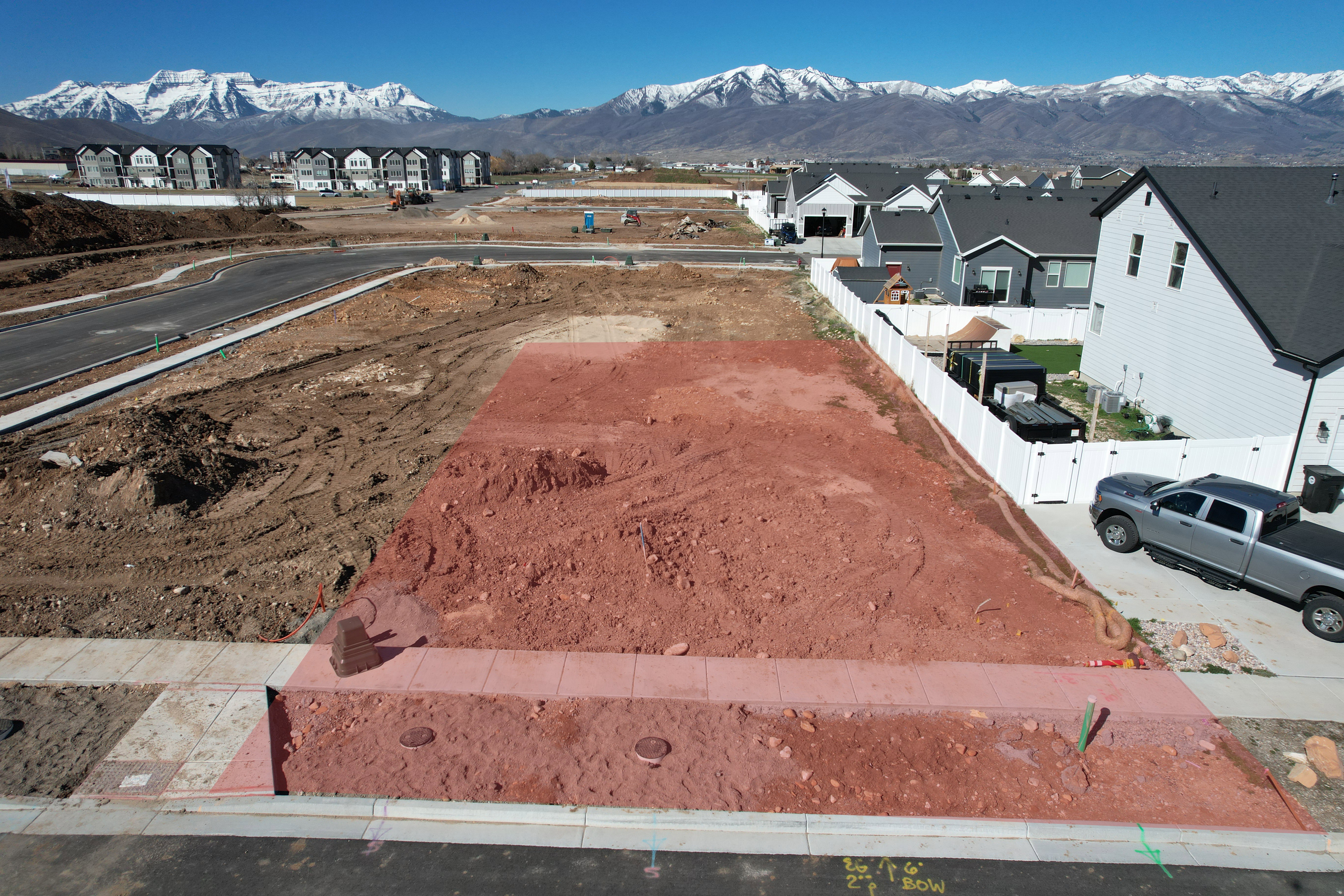 Cleared residential lot with a concrete sidewalk