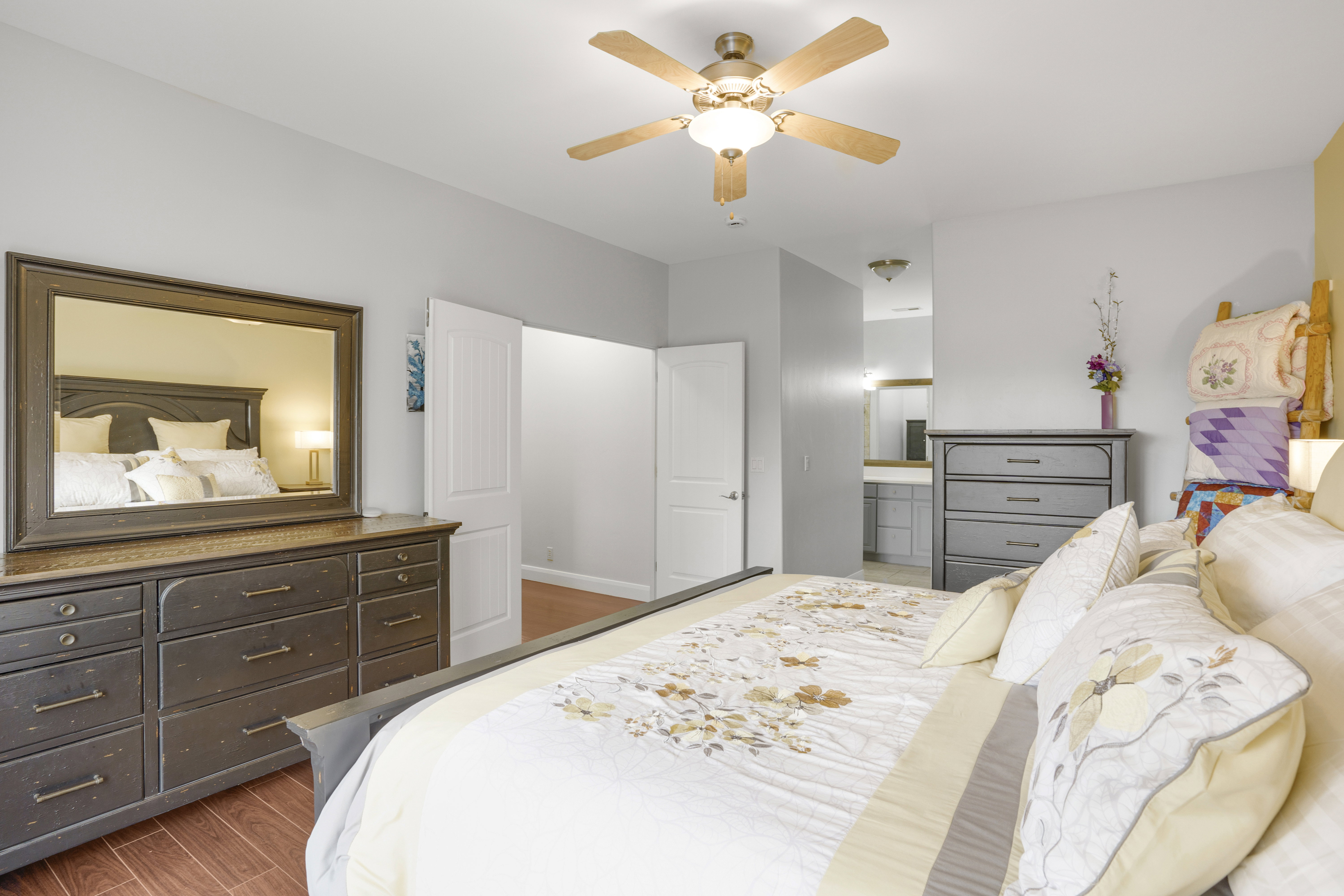 Hardwood-style flooring extends through the room, complemented by light gray walls