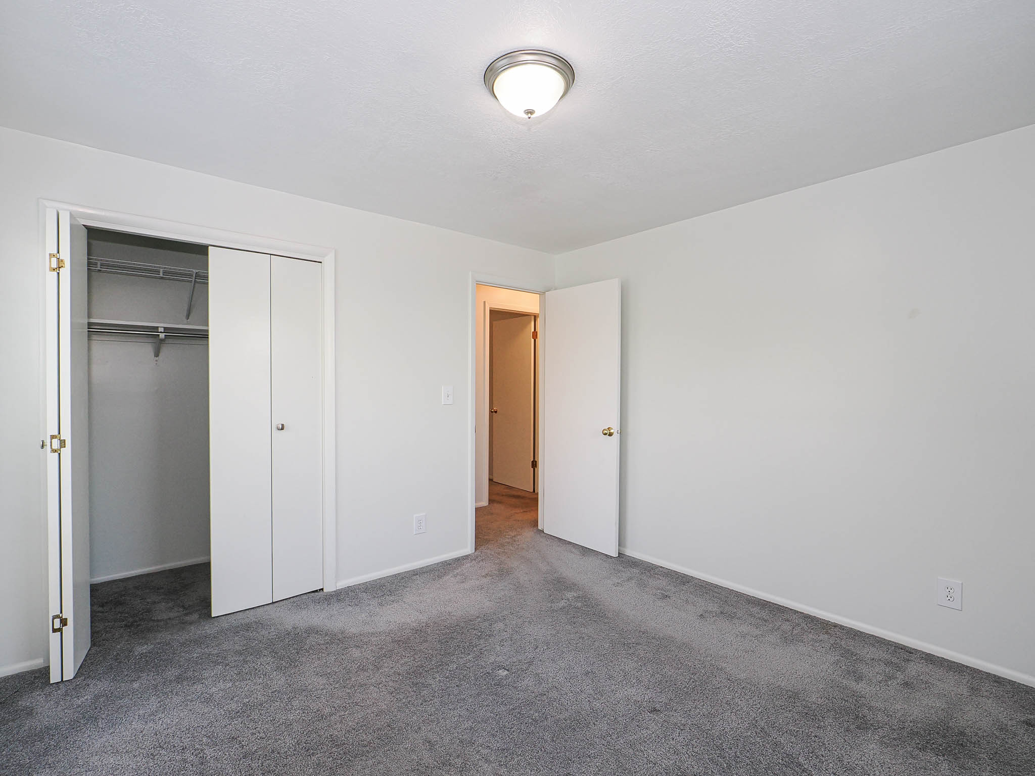 Neutral wall color with gray carpeting