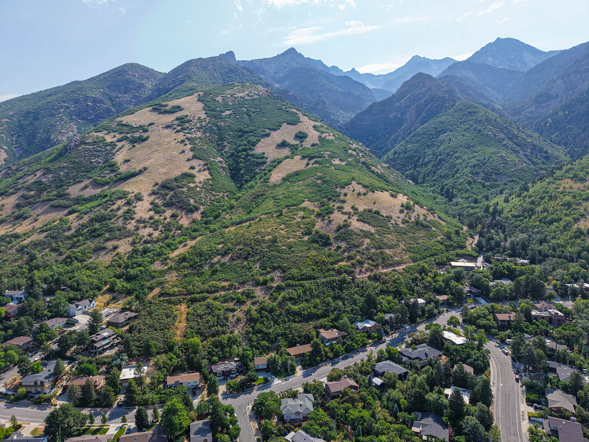 Expansive mountain scenery with a residential area nestled at the base