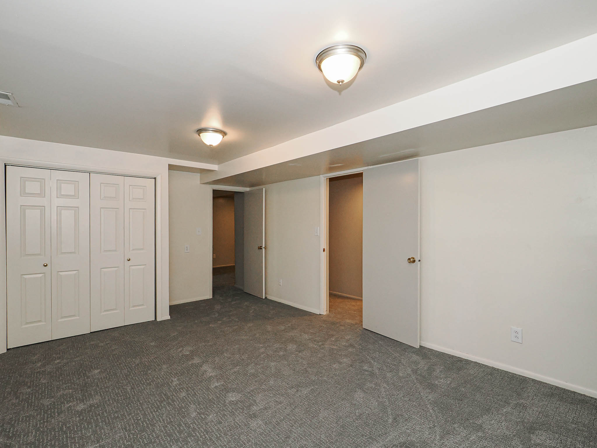 Carpeted interior space featuring white walls and trim