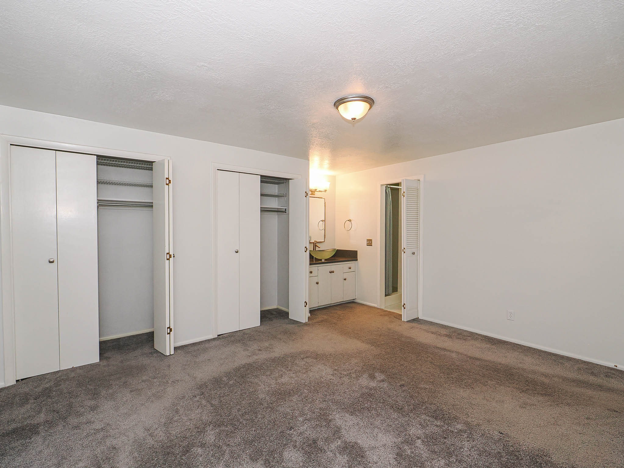 Wall-to-wall carpeting and white walls