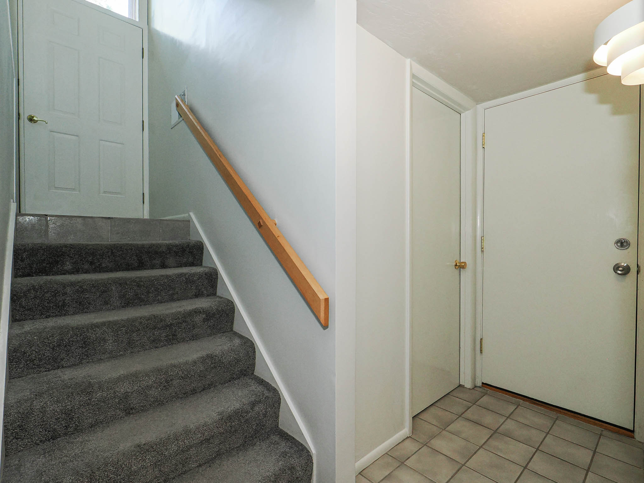 Carpeted staircase with a wood handrail