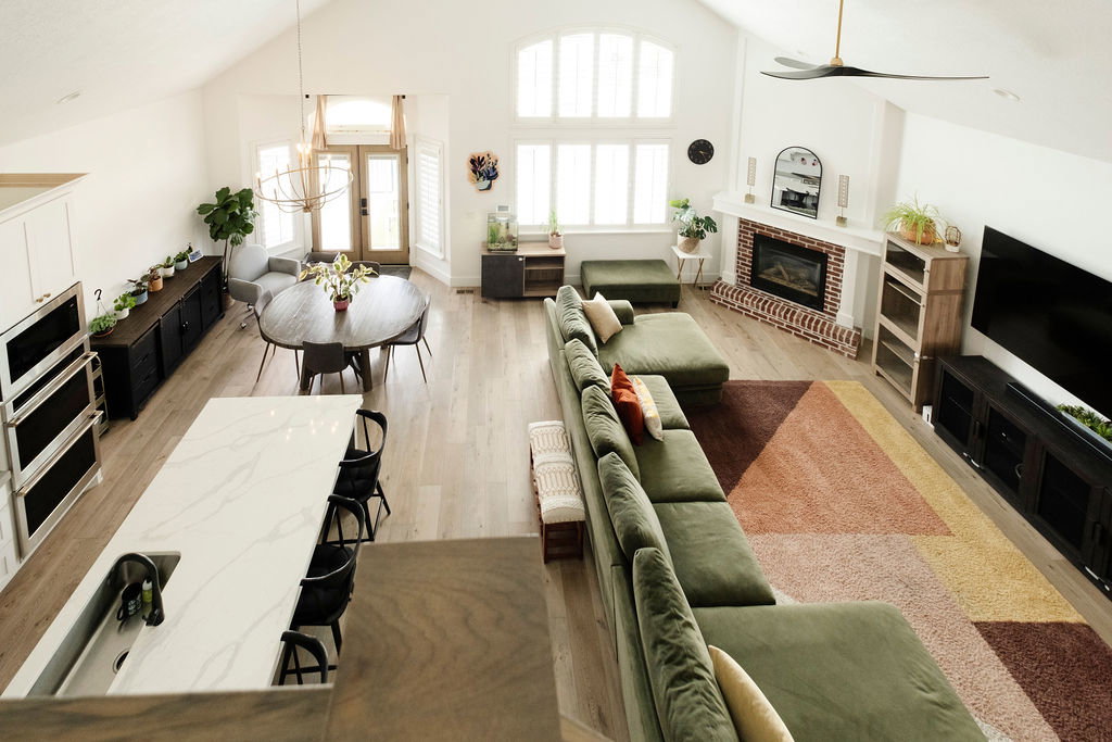 Vaulted ceilings highlight an open-concept living space featuring wood-finish flooring