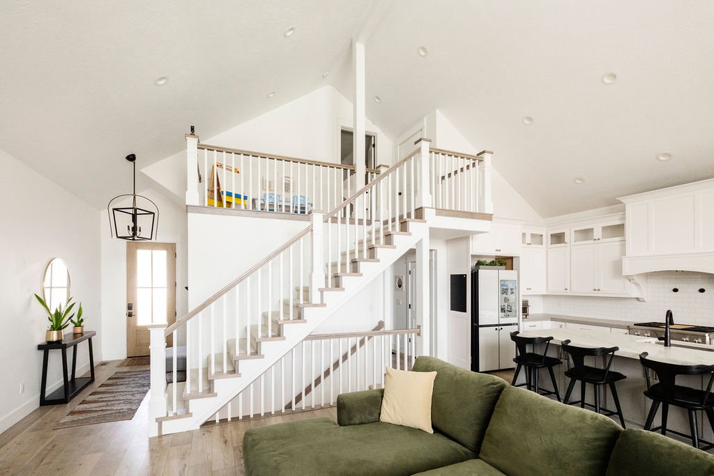 Two-story interior with vaulted ceilings and recessed lighting