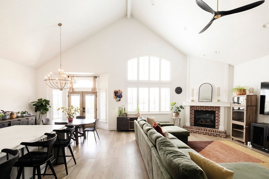 Spacious open-concept interior with vaulted ceilings and wood-finish flooring