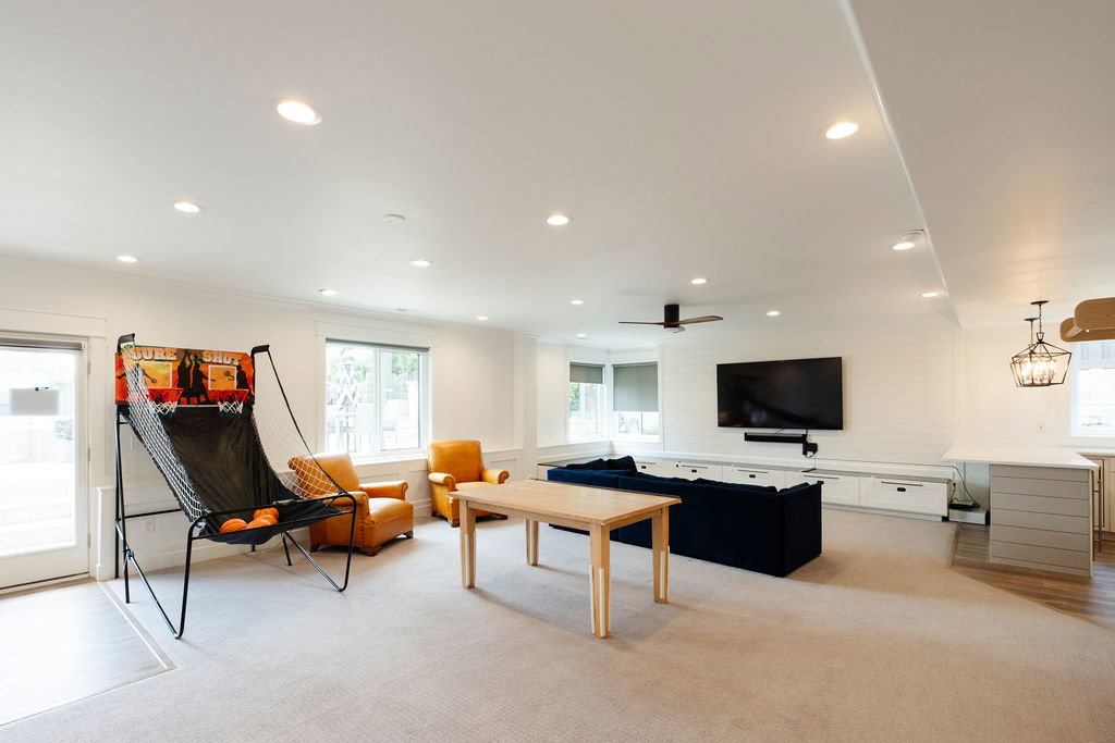 Spacious open-concept room featuring recessed lighting, a ceiling fan, and shiplap accent wall