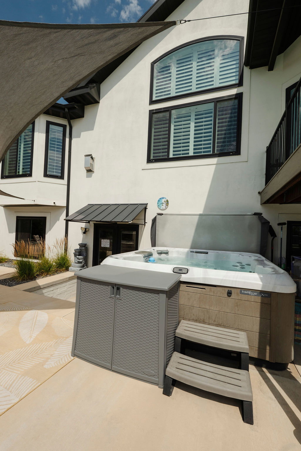 Outdoor spa with steps on a concrete patio