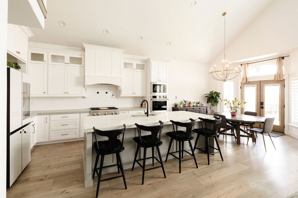 Light wood-finish flooring throughout an open-concept kitchen and dining area