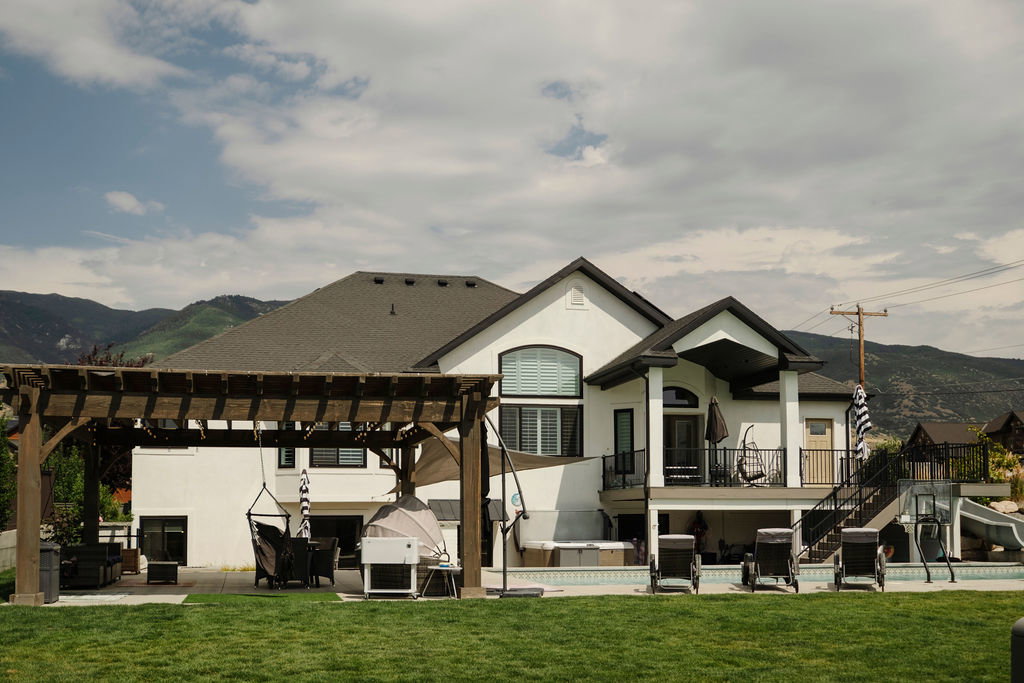 Contemporary exterior with white stucco finish and dark trim