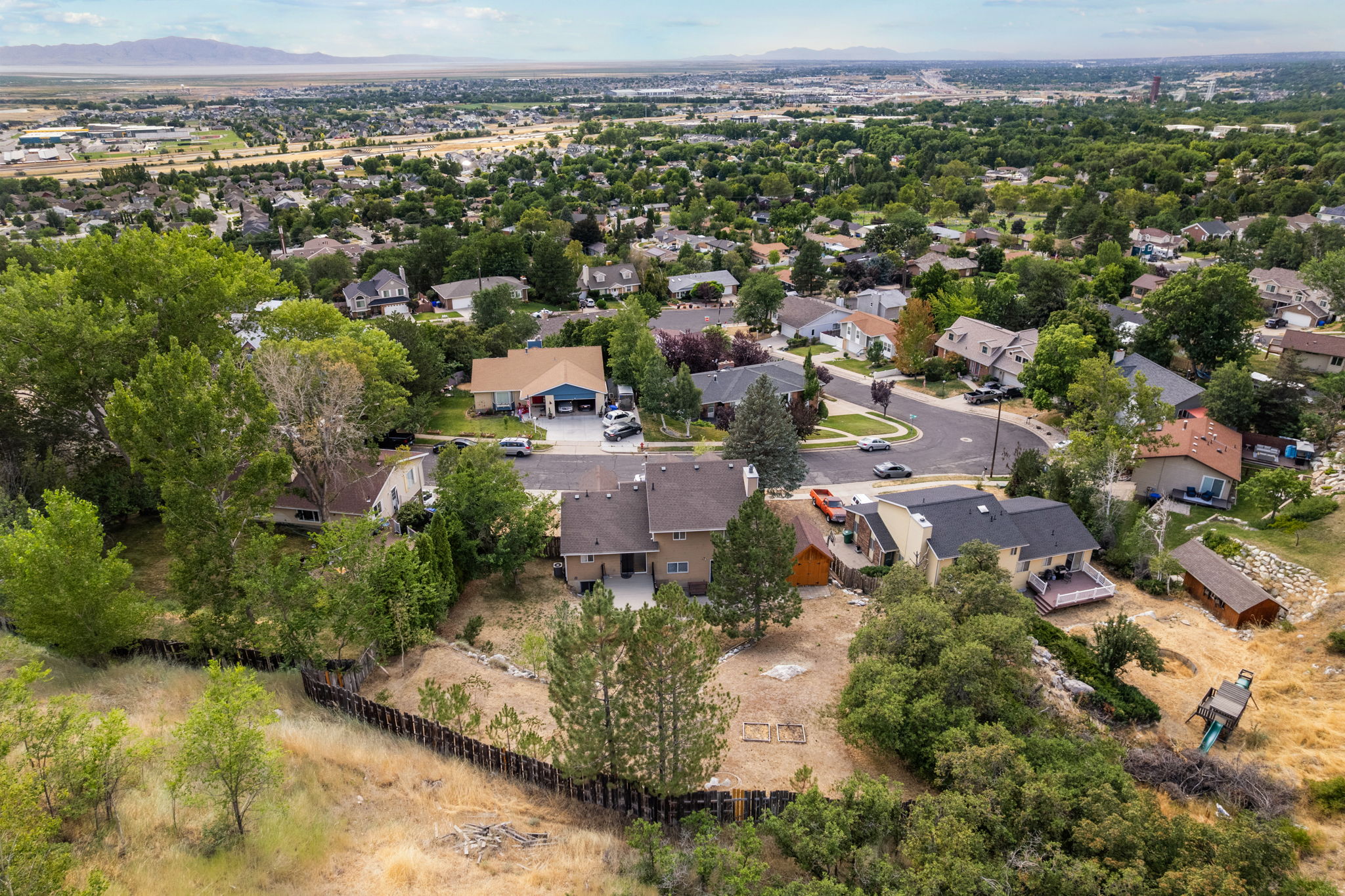 Aerial perspective showcasing a residential area with varied housing styles and mature tree cover