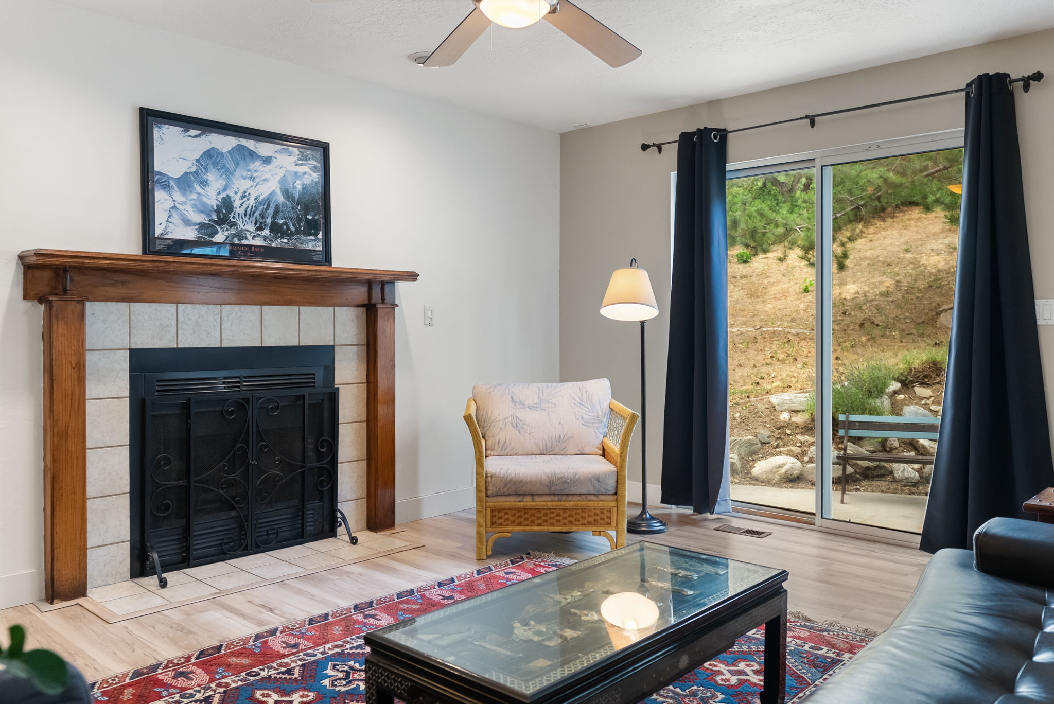 Living area featuring a fireplace with a wood mantle and tile surround