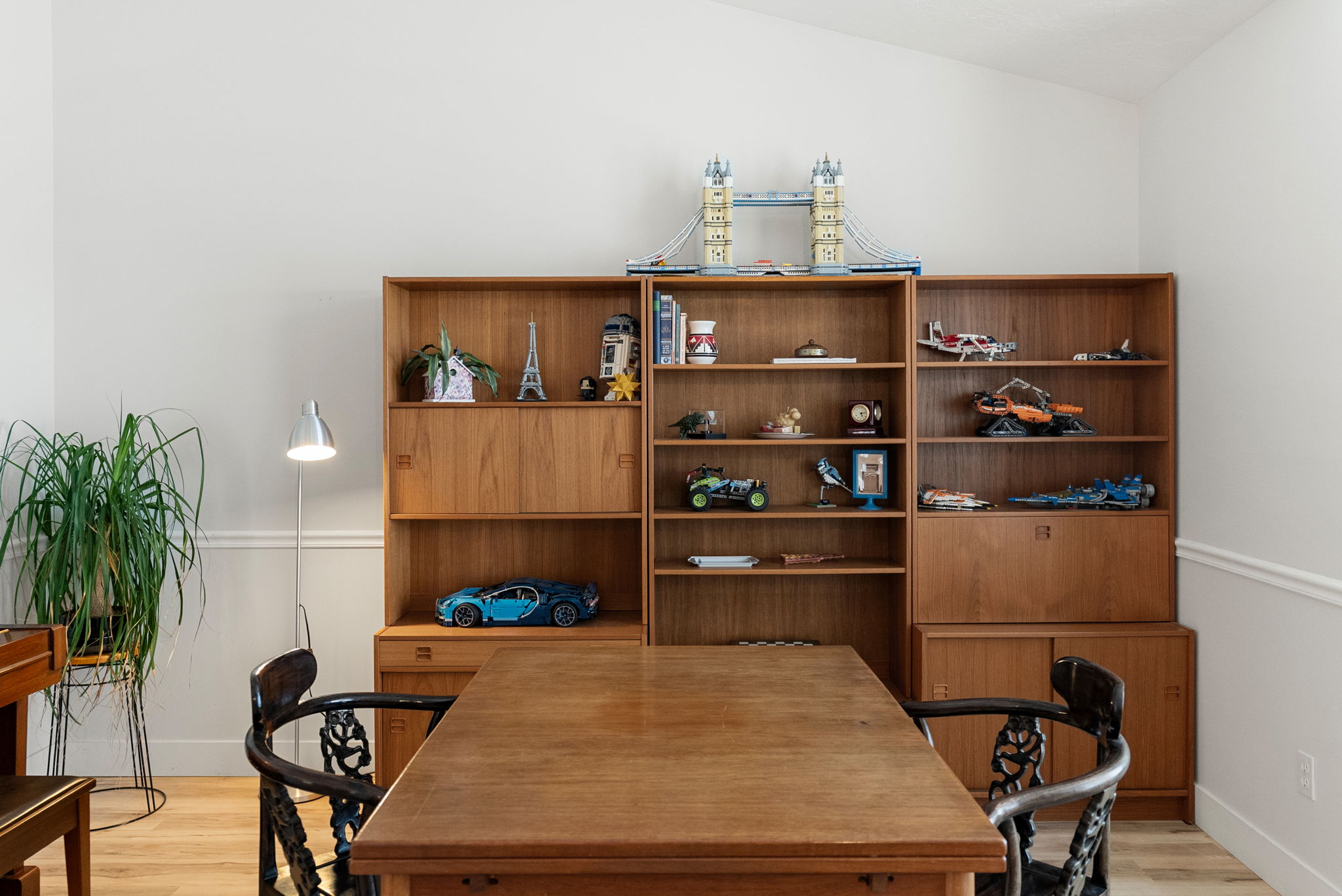 Wood-finish flooring and white walls with decorative molding
