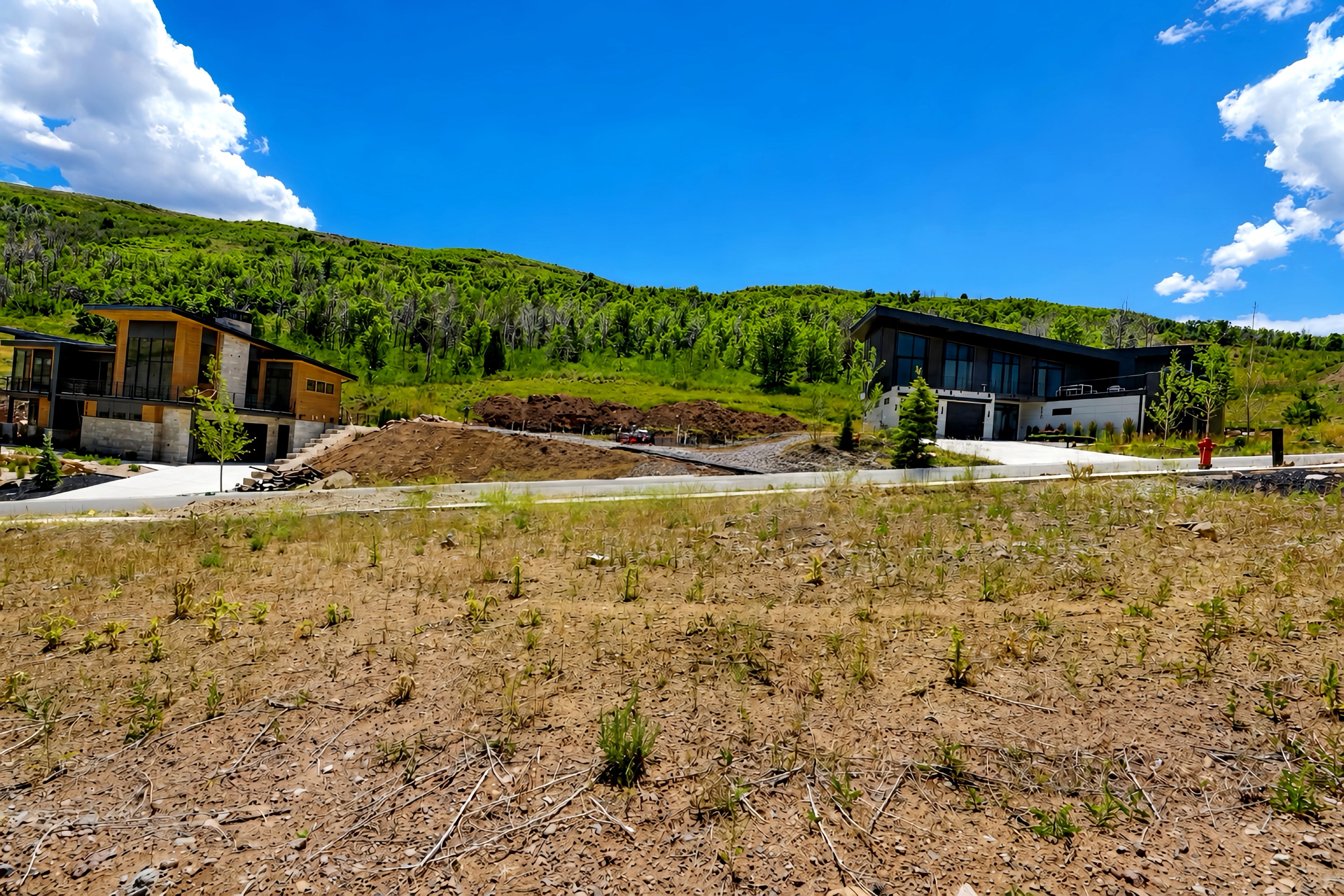 Modern architecture featuring expansive windows, wood-panel siding, and stone accents