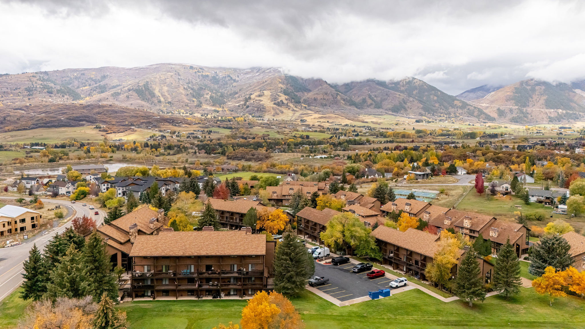 Mountain-backed community featuring multi-story buildings with brown exteriors and balconies
