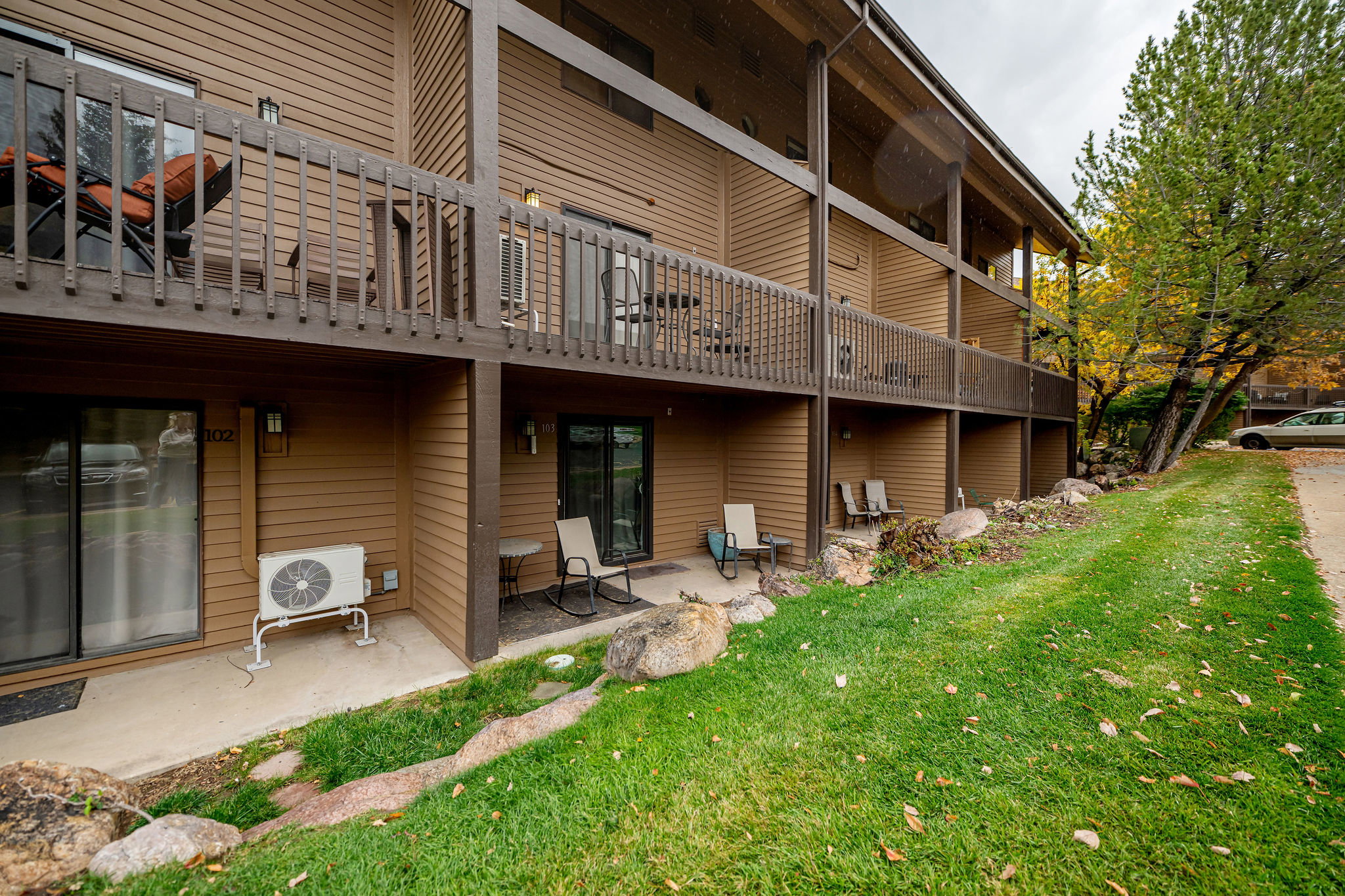 Multi-level building exterior featuring horizontal siding and dark trim