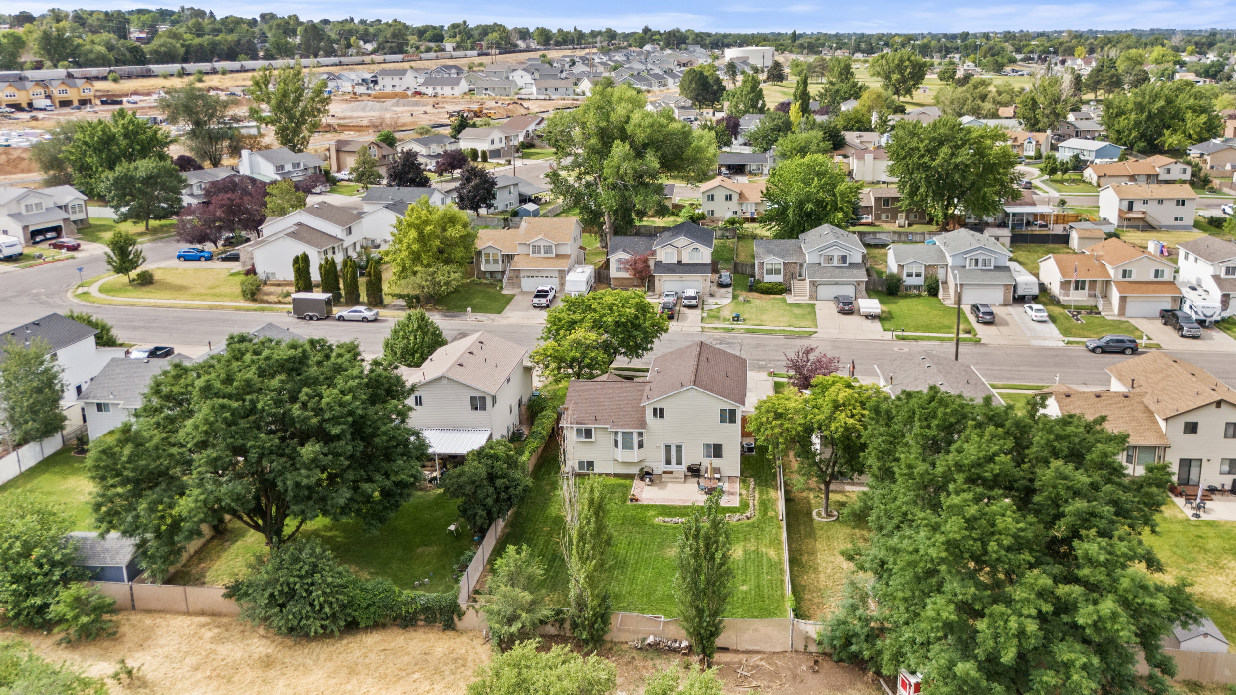 Aerial perspective showcasing a residential neighborhood with established homes and tree-lined streets