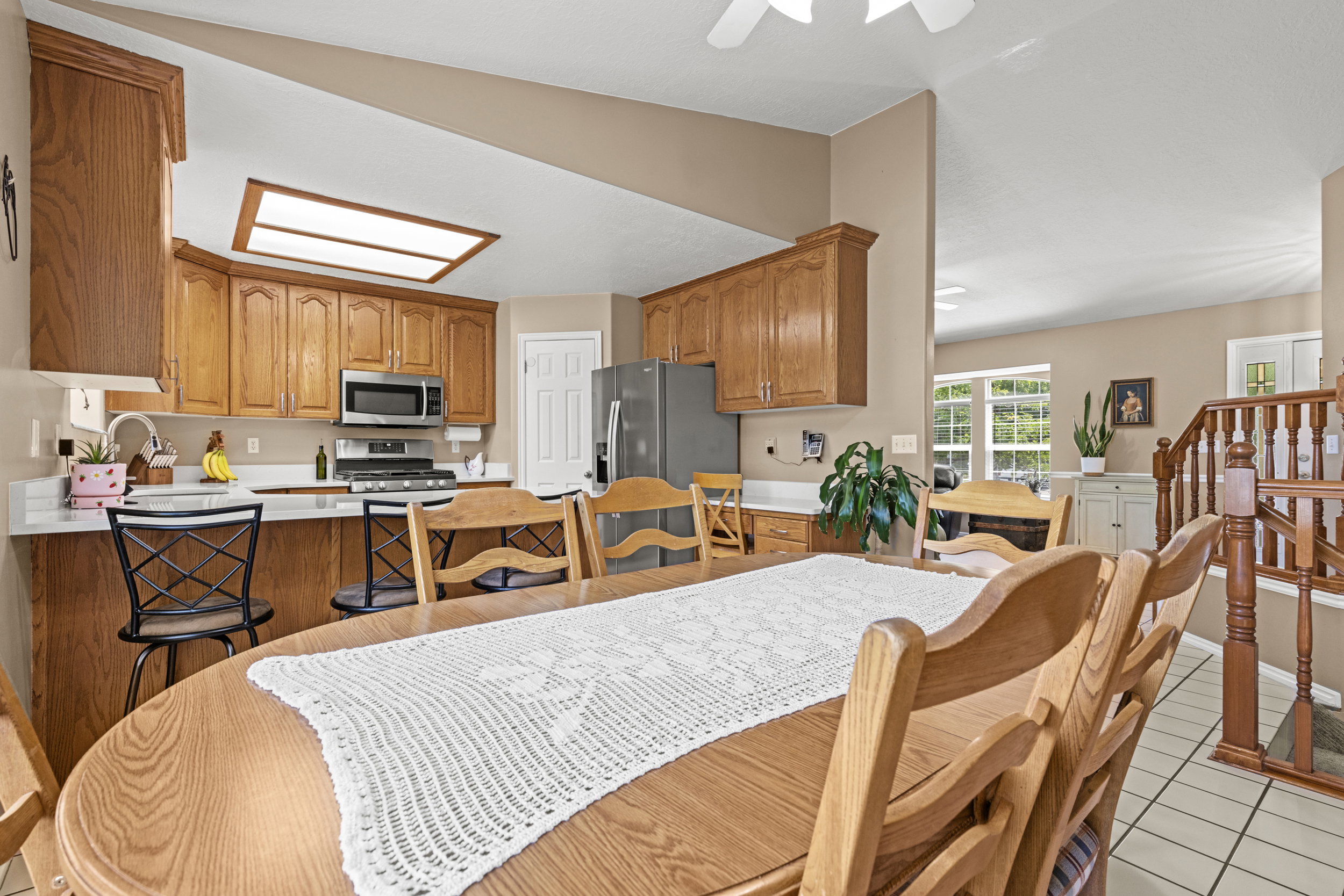 Dining area featuring wood-finish flooring and a wood staircase
