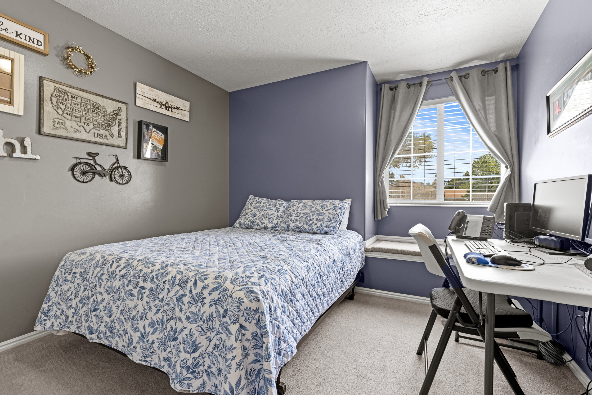 Room featuring a window with natural light, a window sill, two-tone wall paint, and light-colored carpet flooring