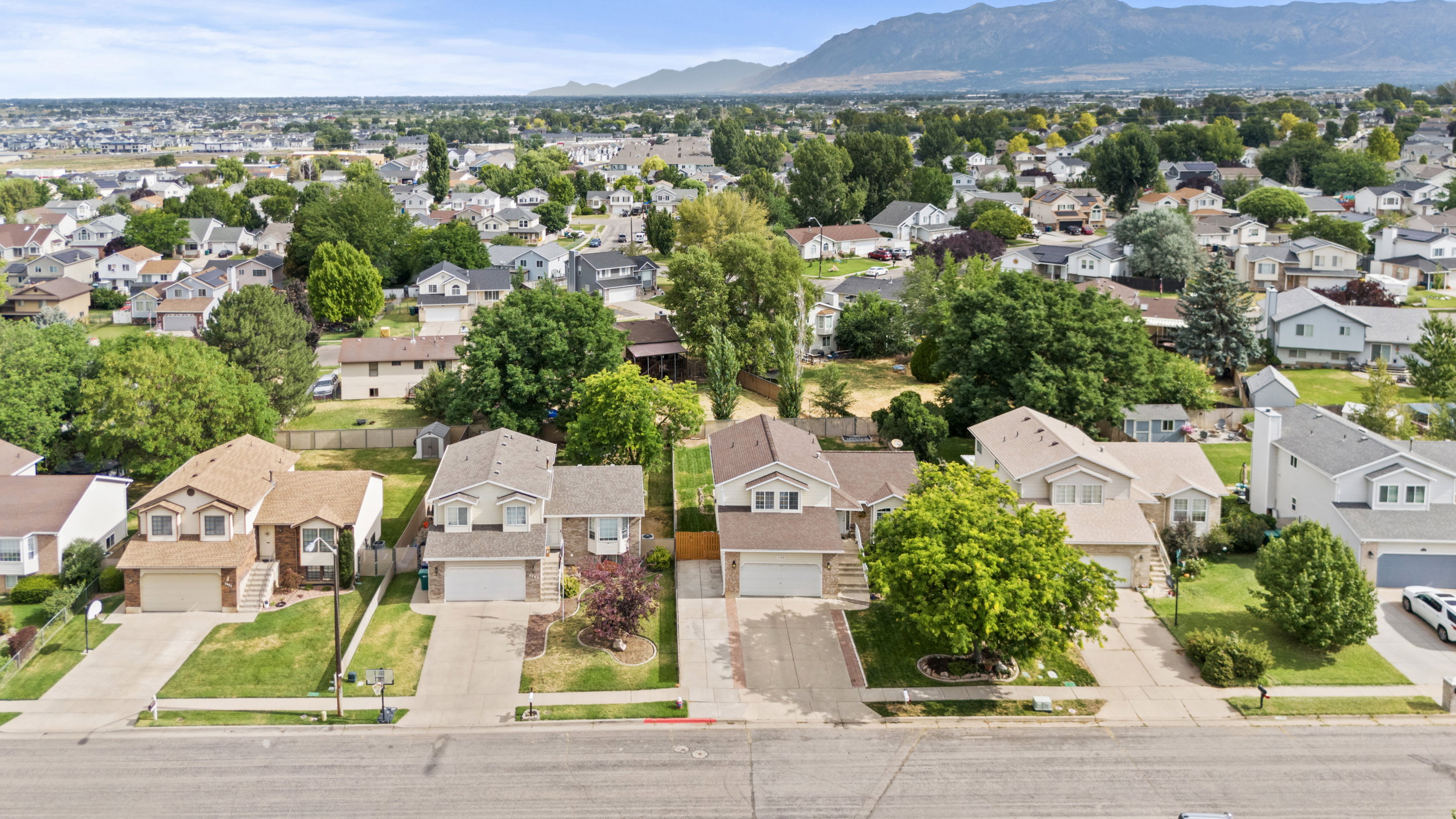 Aerial perspective showcasing a residential neighborhood with mountain backdrop