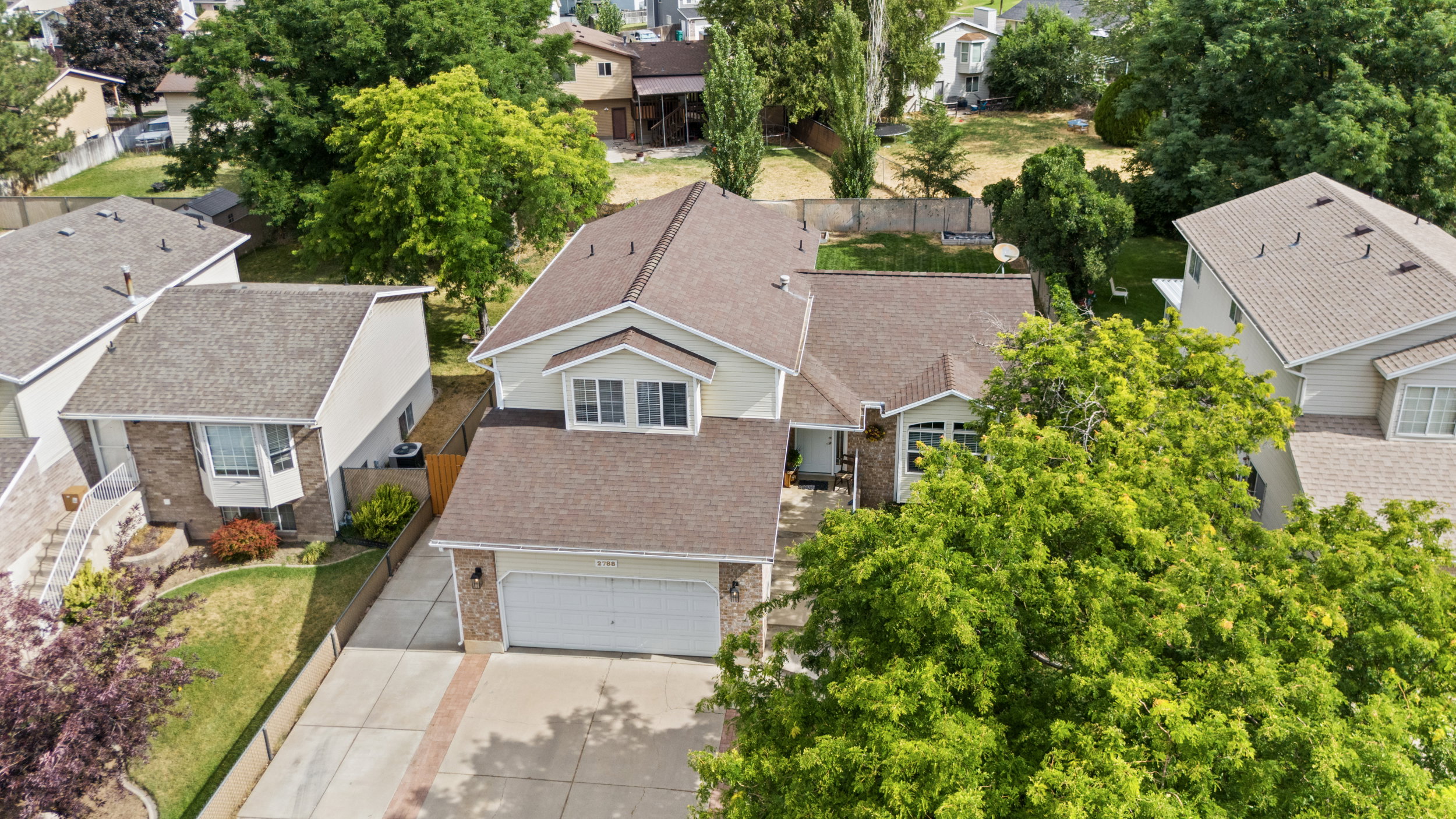 Two-story residence featuring a two-car garage, brick and siding exterior, and a gabled roofline