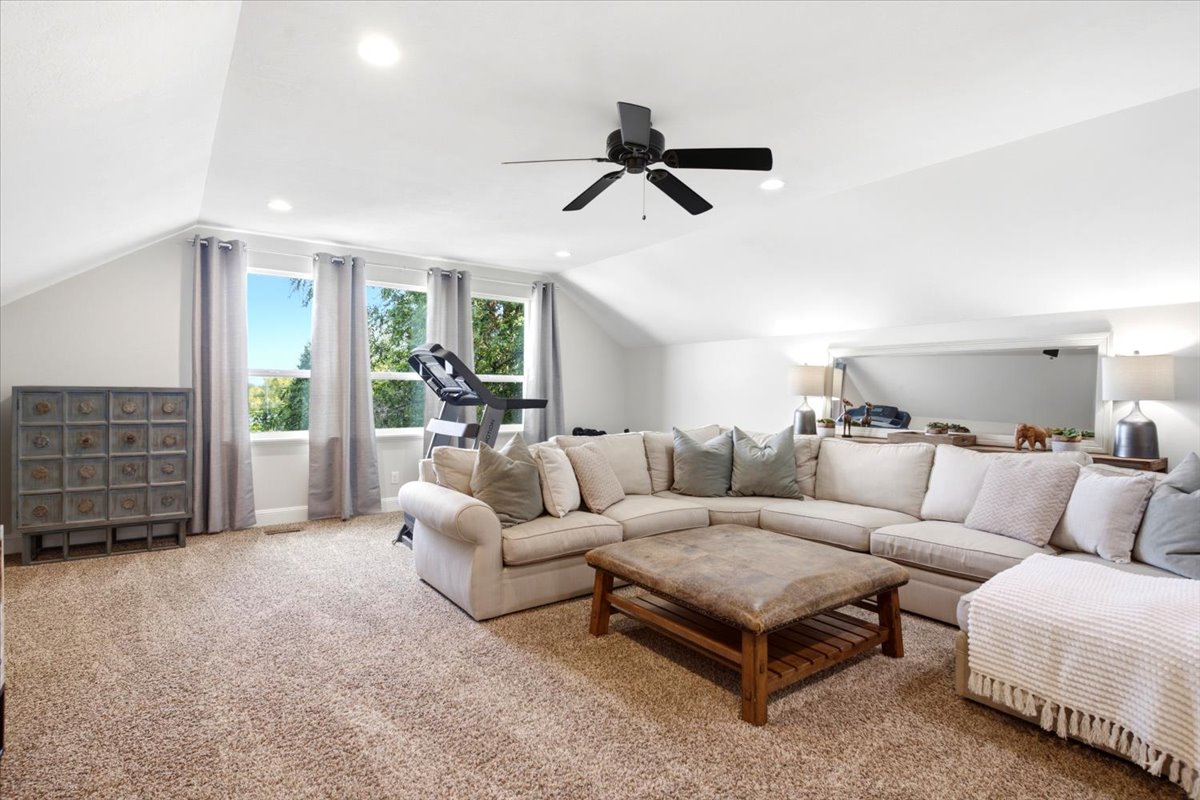 Carpeted bonus room with vaulted ceilings, recessed lighting, and a contemporary ceiling fan