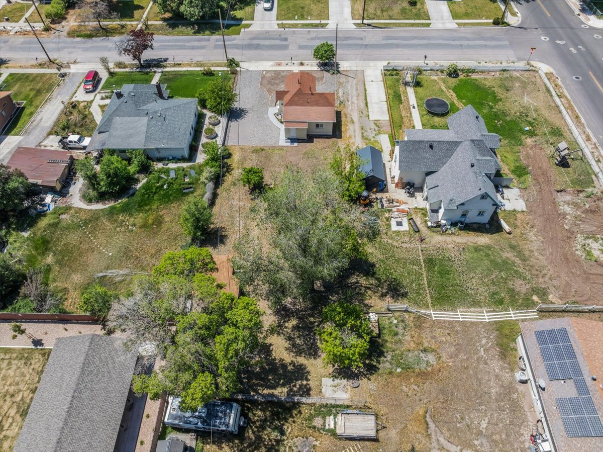 Expansive property featuring a large land parcel, mature trees, and existing residential structures