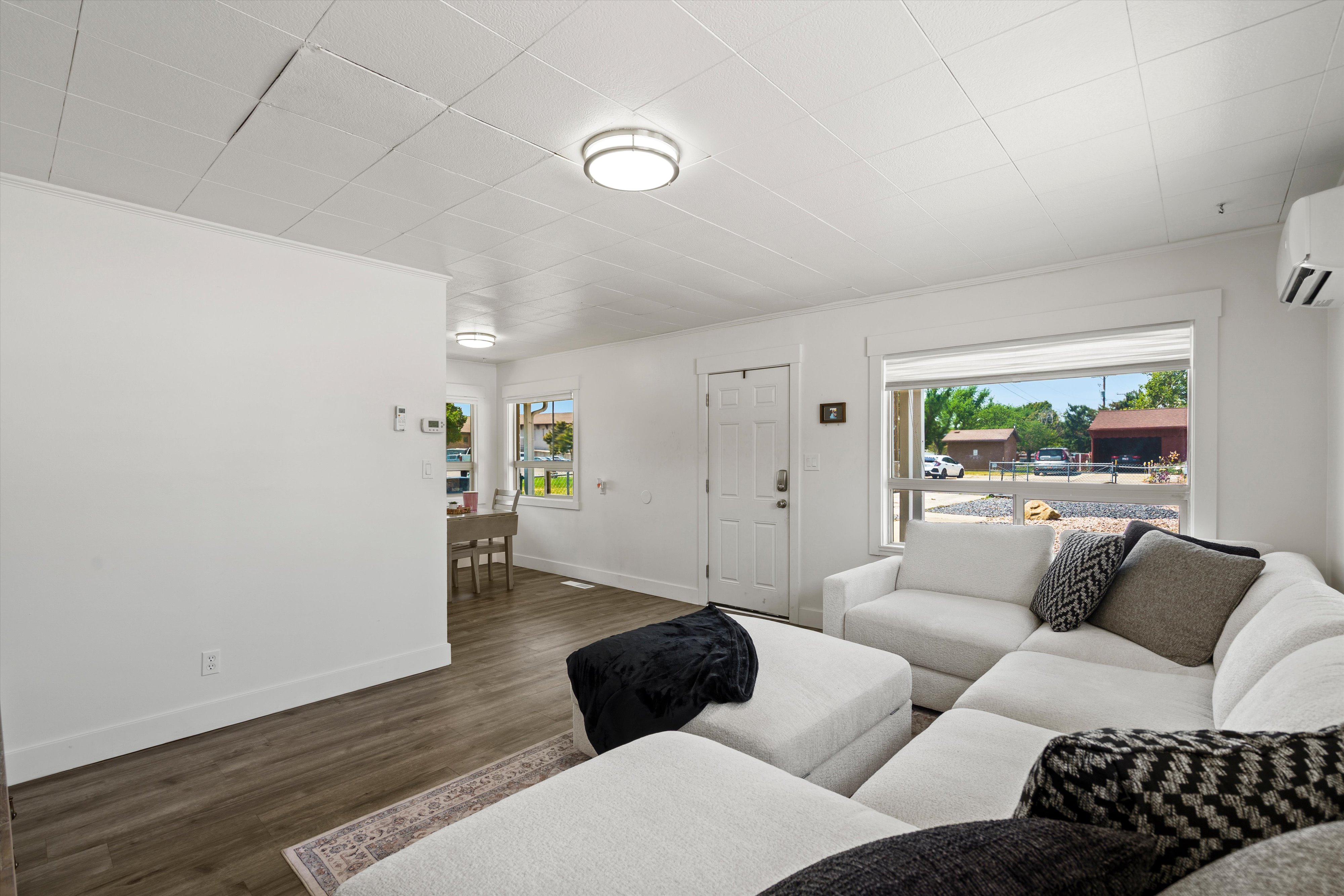 Open concept living area with wood-finish flooring