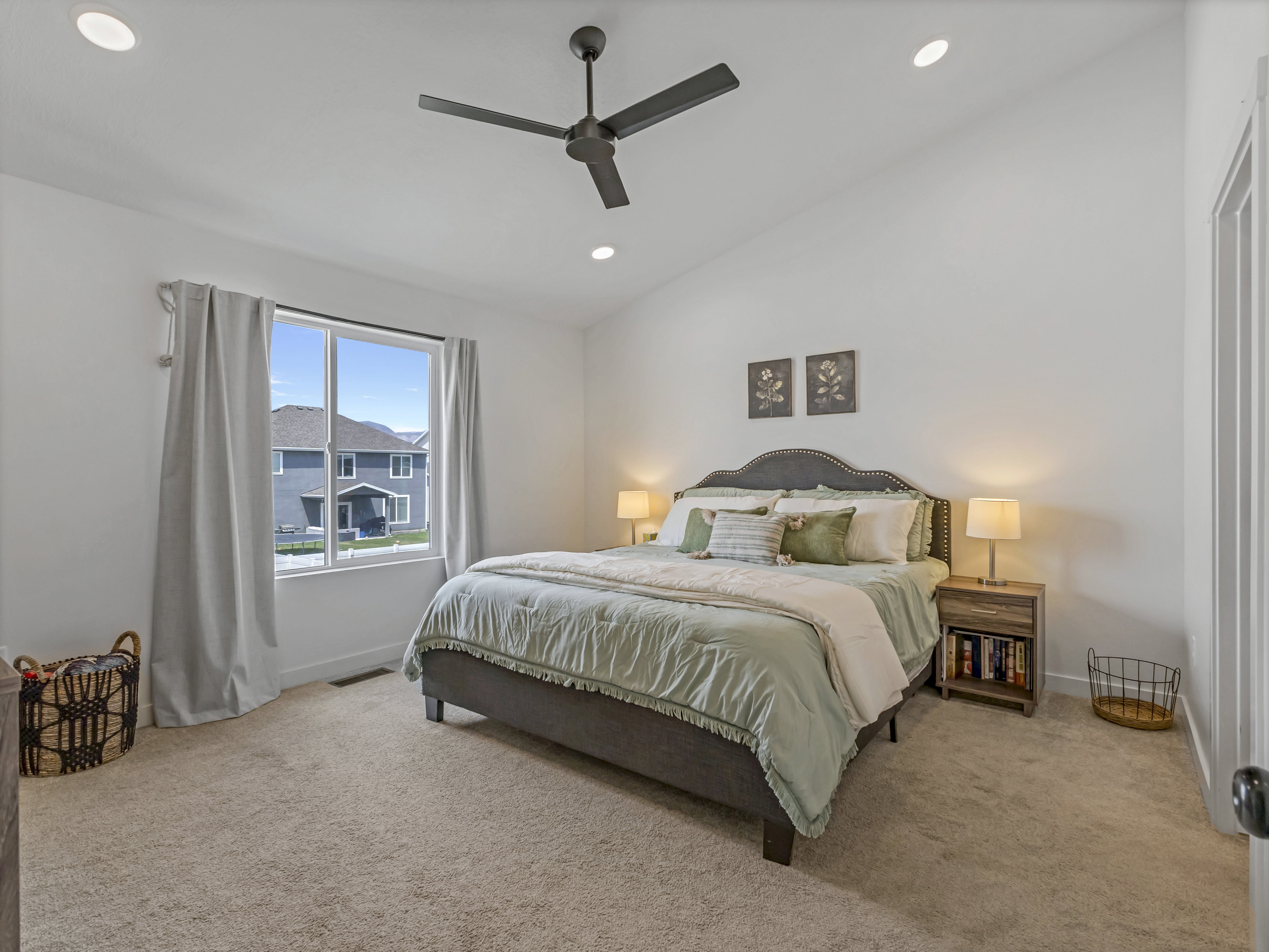 Spacious bedroom featuring vaulted ceilings, recessed lighting, a ceiling fan, and plush carpeting