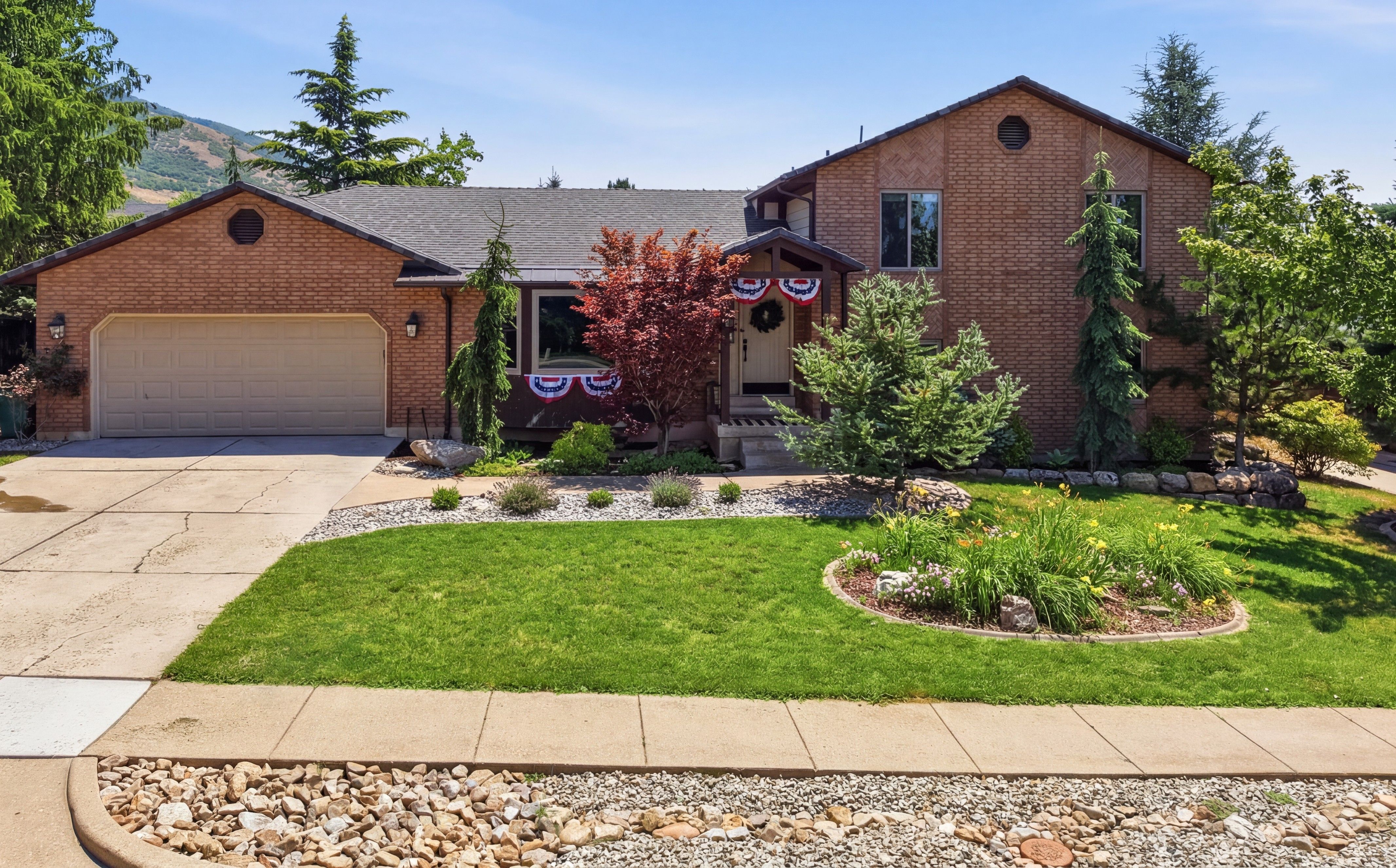 Brick exterior residence featuring an attached garage with a concrete driveway