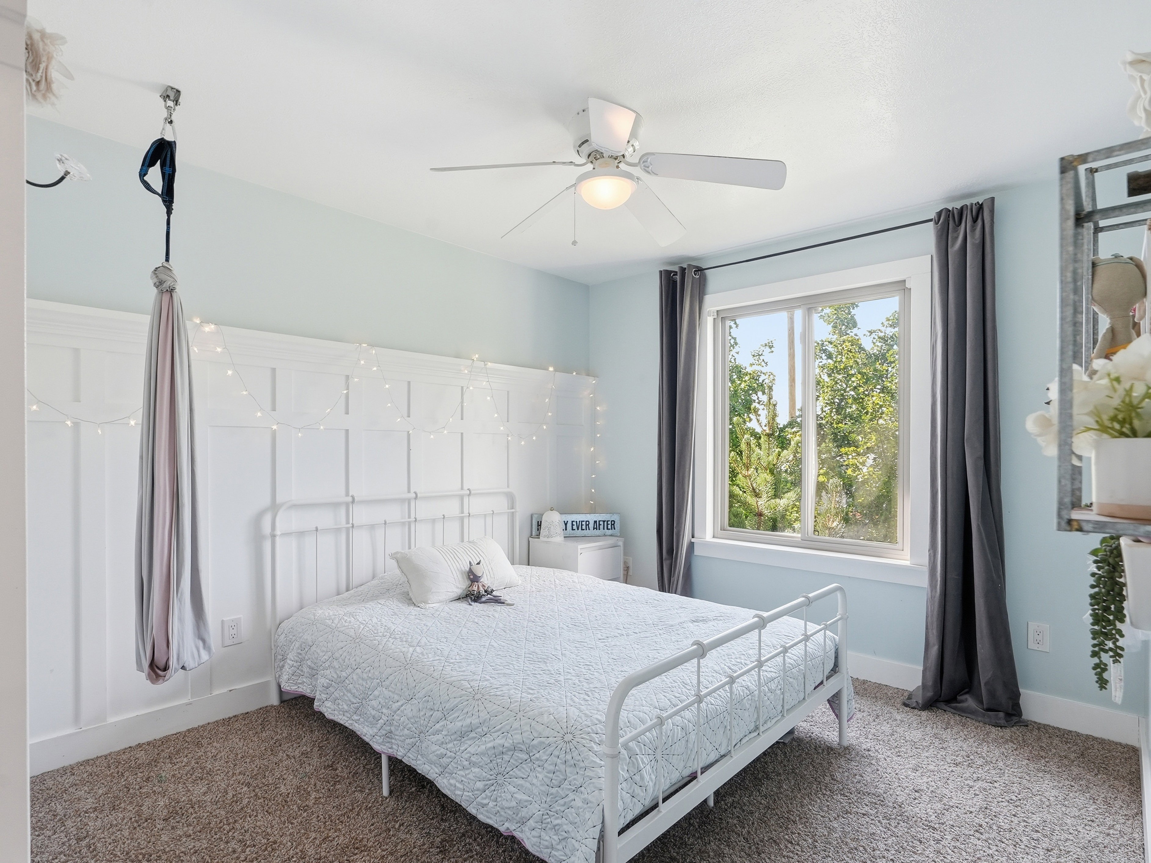 Light blue walls featuring a white board and batten accent wall