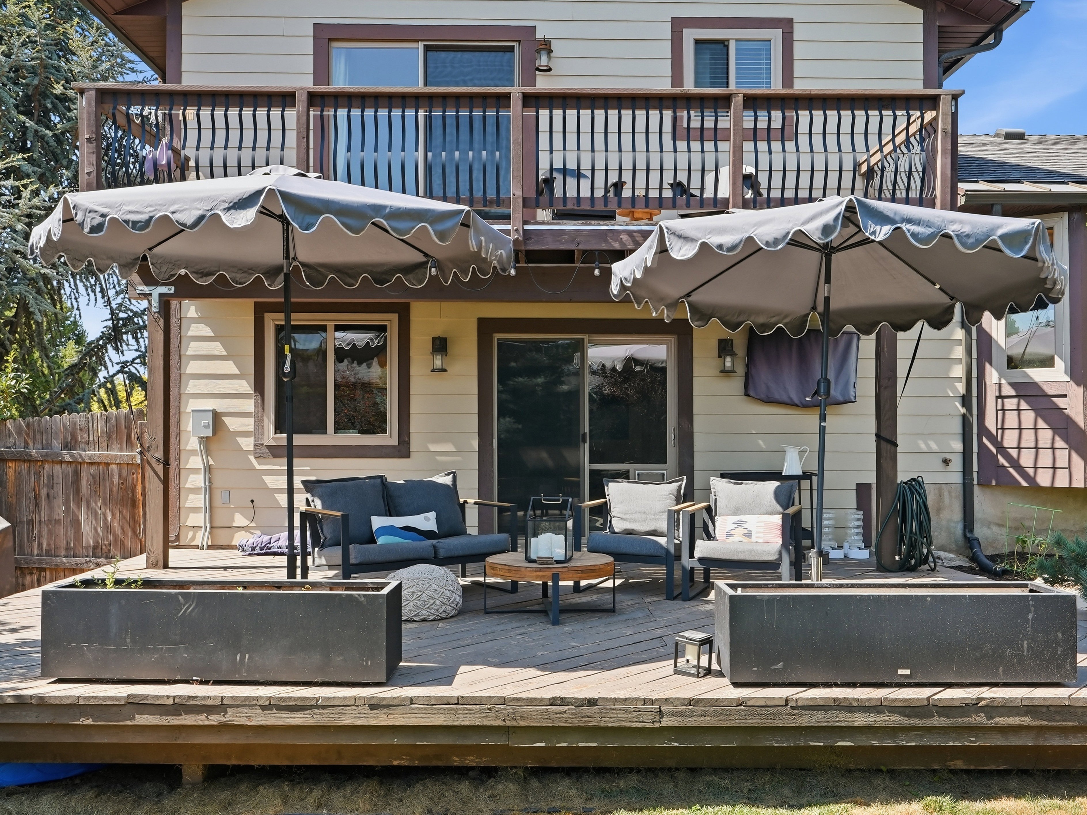 Multi-level wood deck featuring a lower patio area and an upper balcony