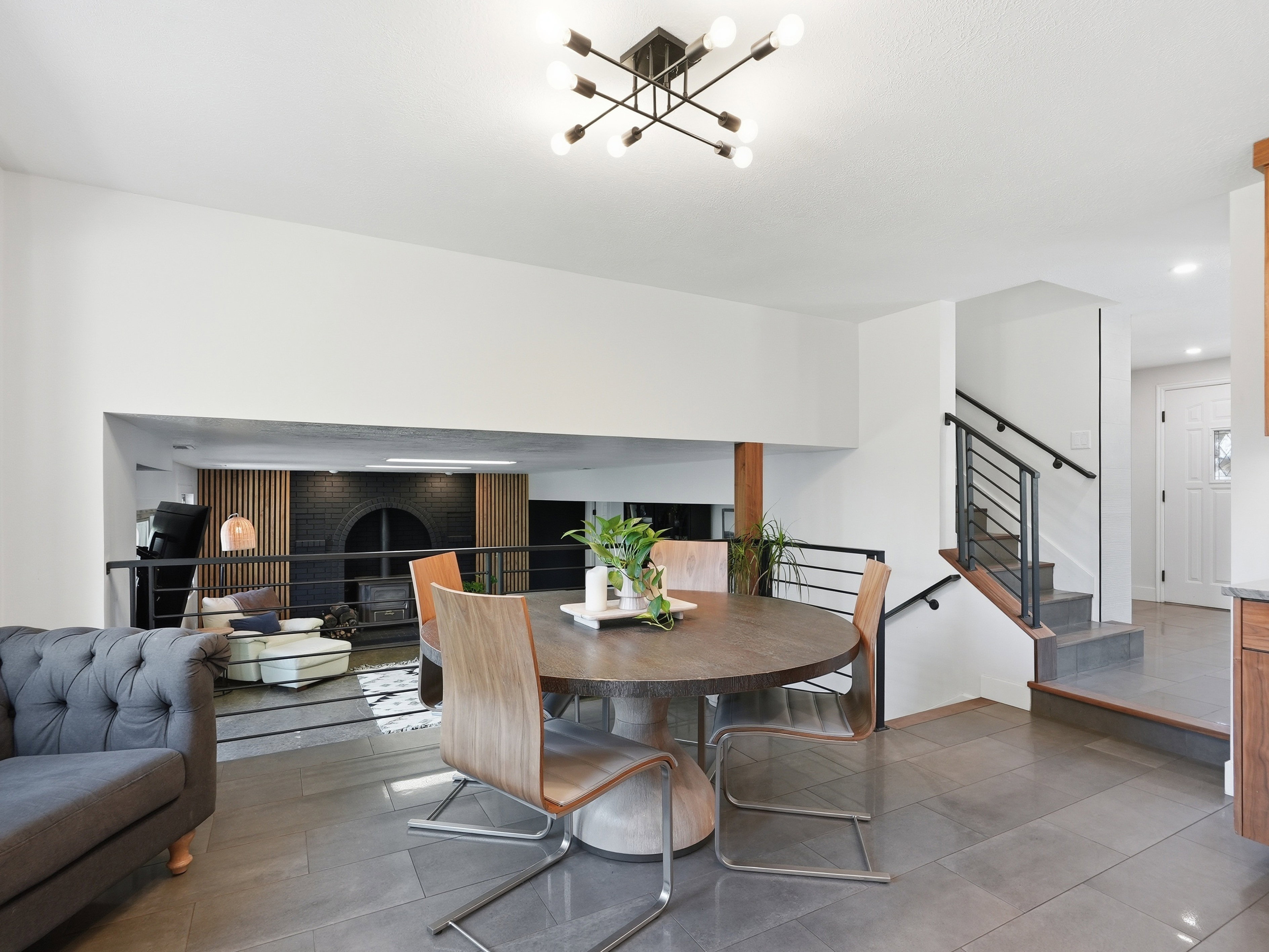 Open concept interior featuring a dining area with a modern chandelier and hard surface flooring