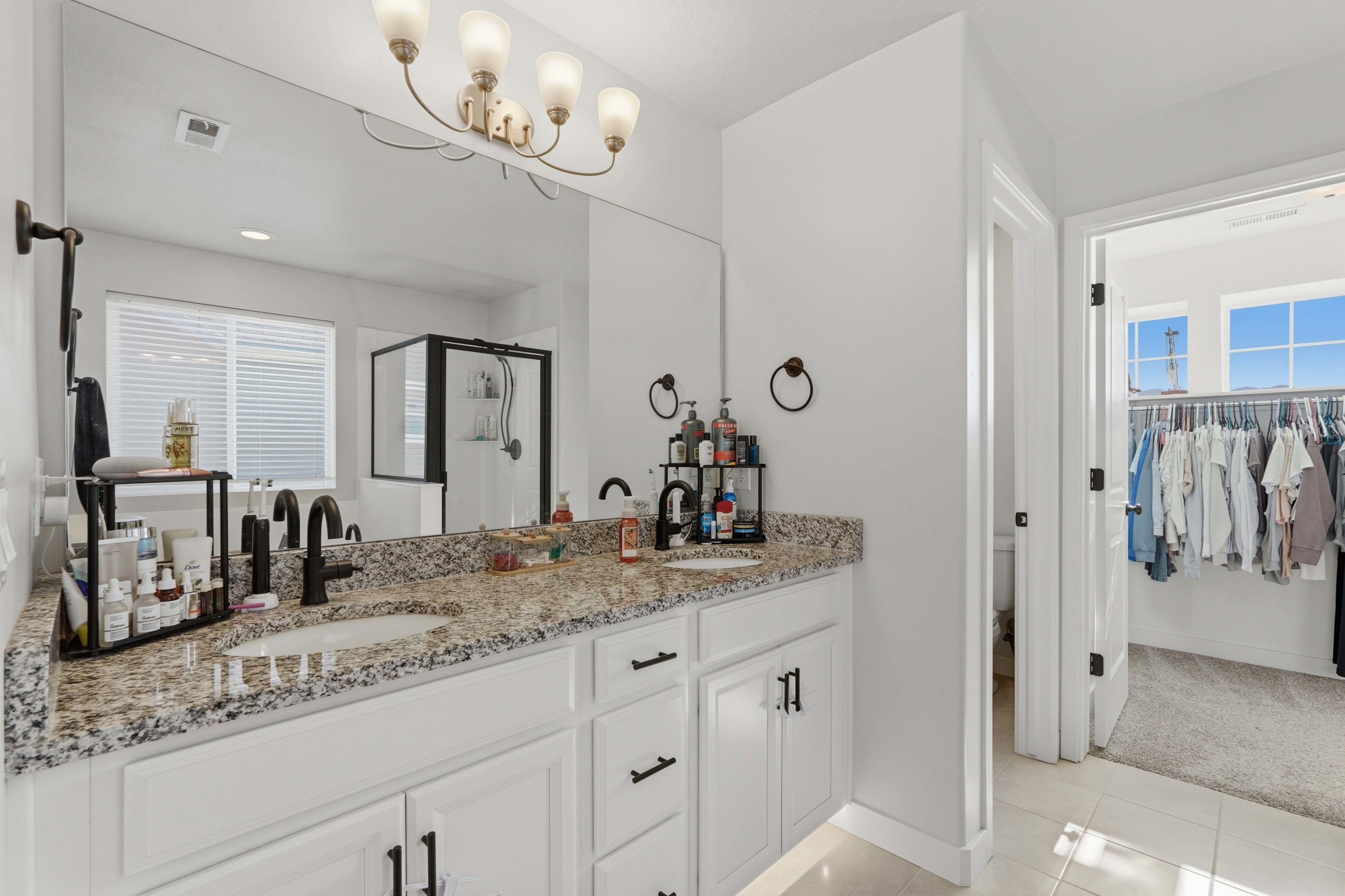Double vanity with granite countertop, undermount sinks, and upgraded under cabinets lighting