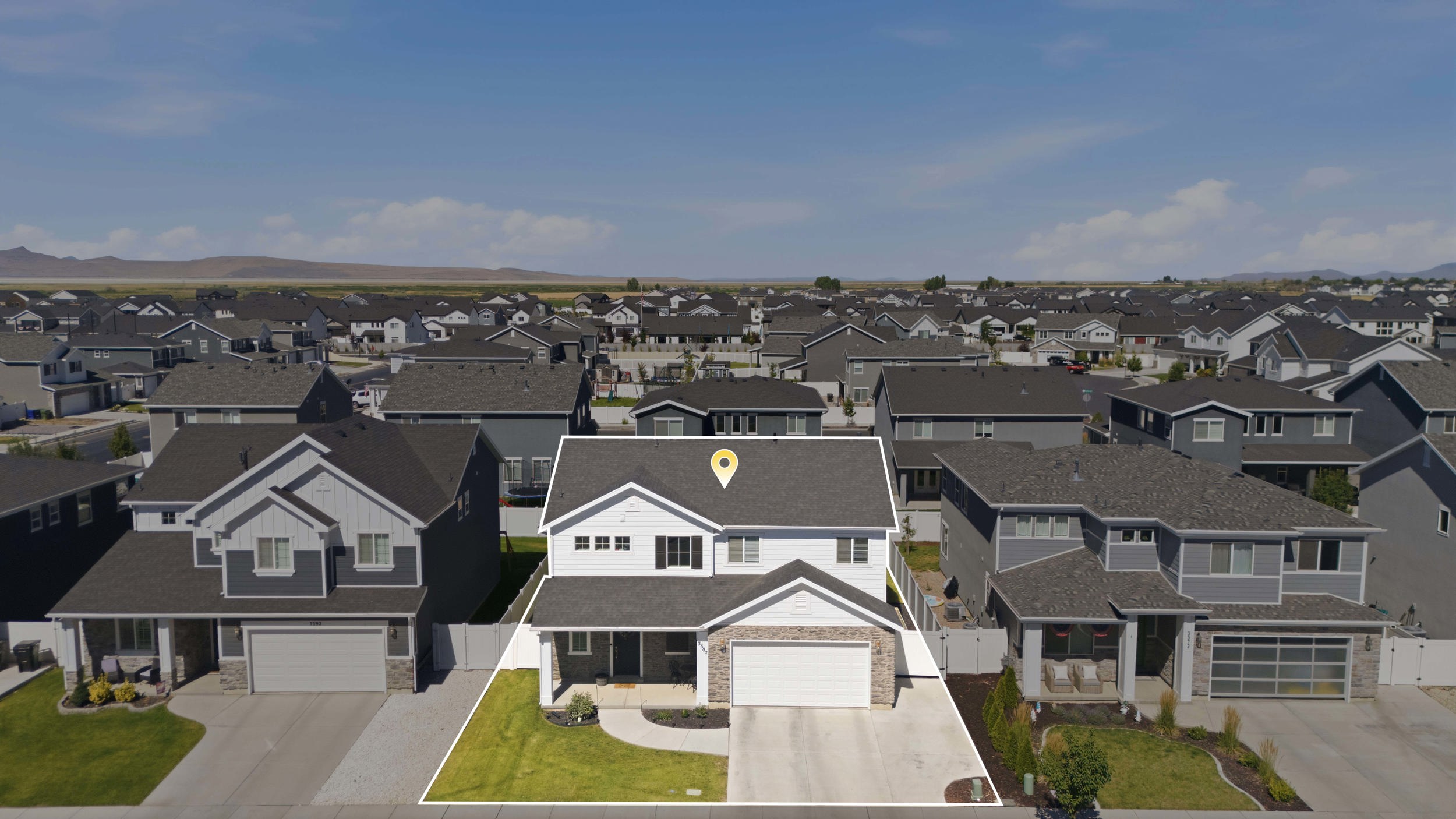 Two-story residence featuring white siding and dark gray shingle roofing