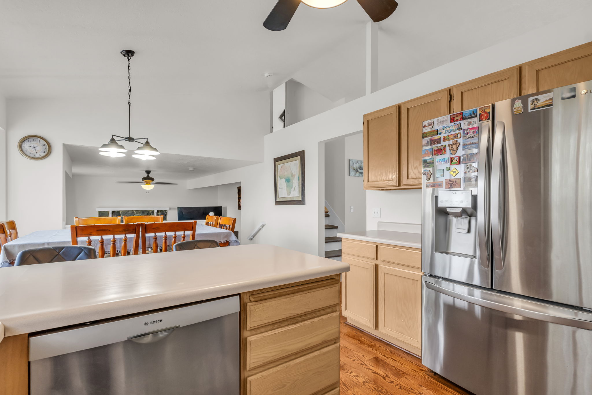 Kitchen with light wood-finish cabinetry, stainless steel appliances, and a light-toned countertop