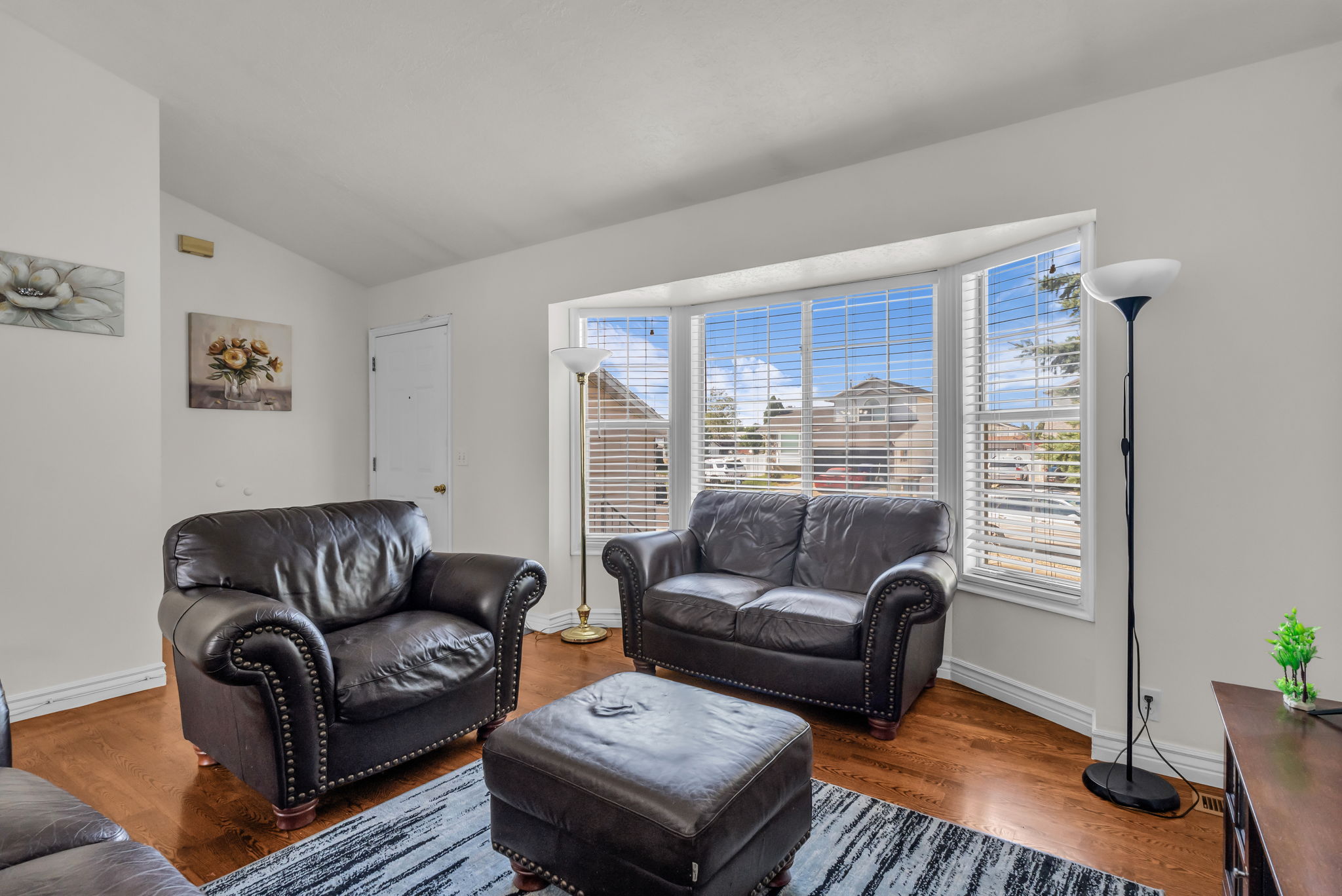 Bay window with horizontal blinds, showcasing white trim
