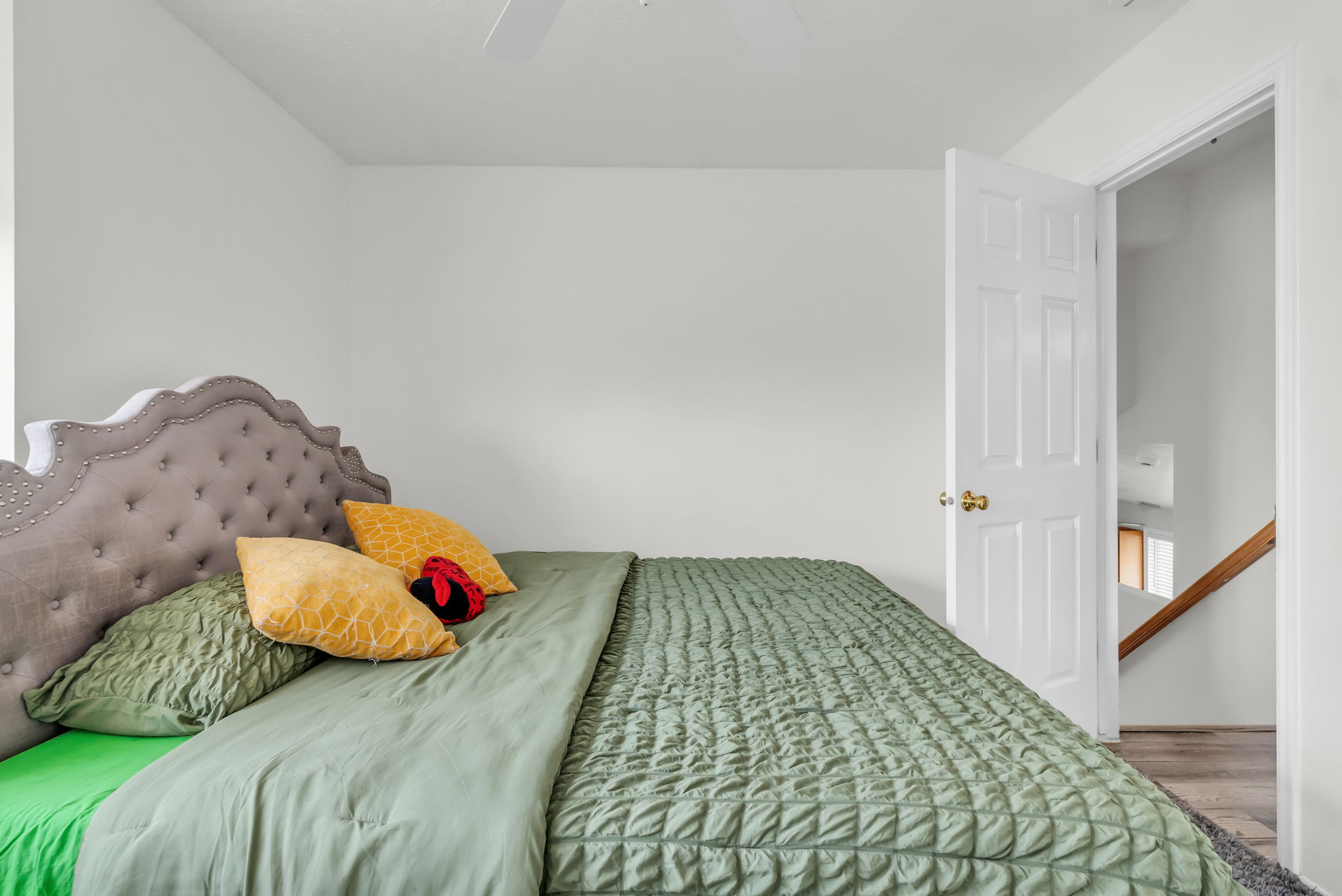 Room featuring white walls, a white ceiling, and a ceiling fan