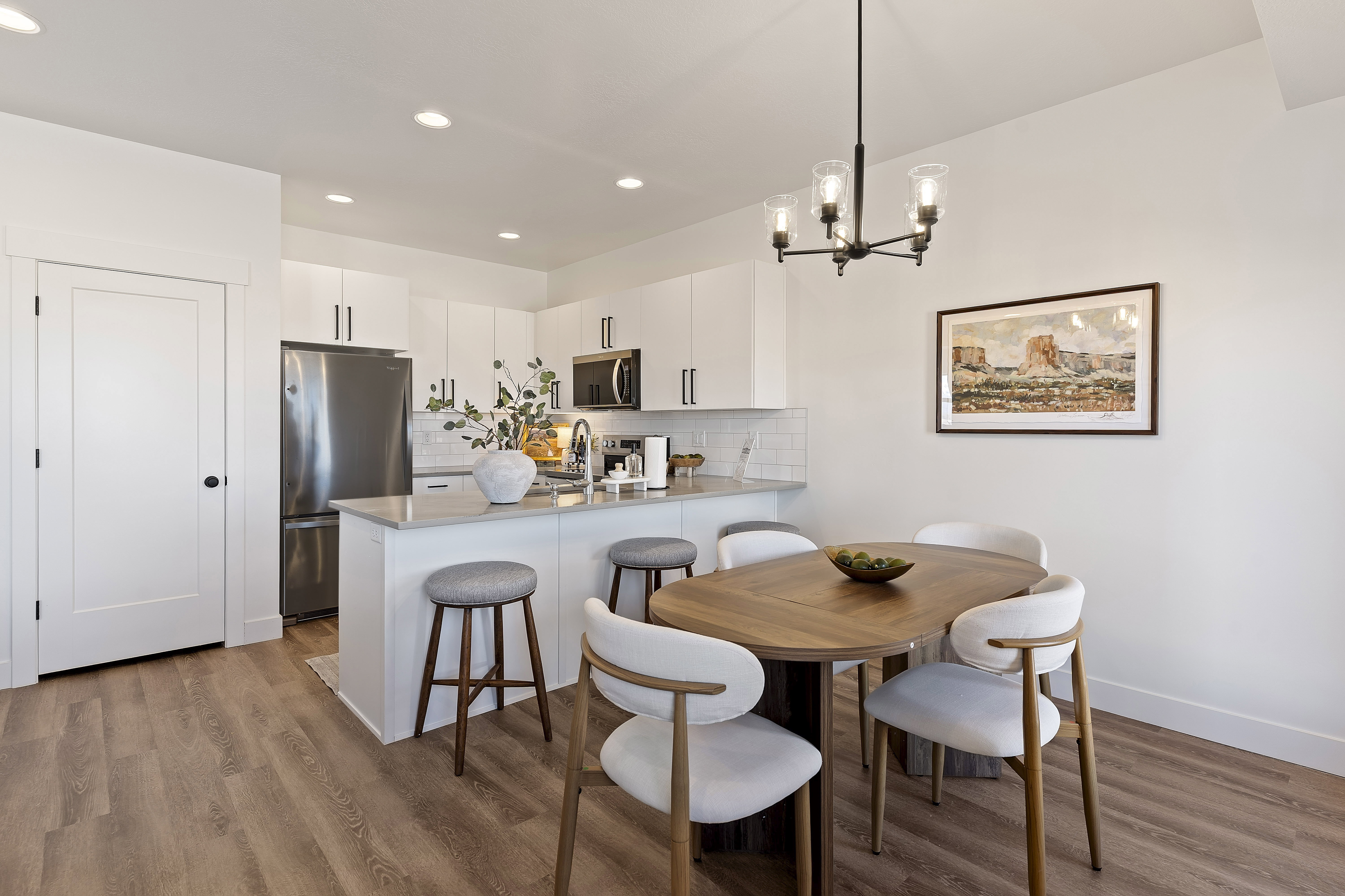 Open-concept kitchen and dining area featuring wood-finish flooring