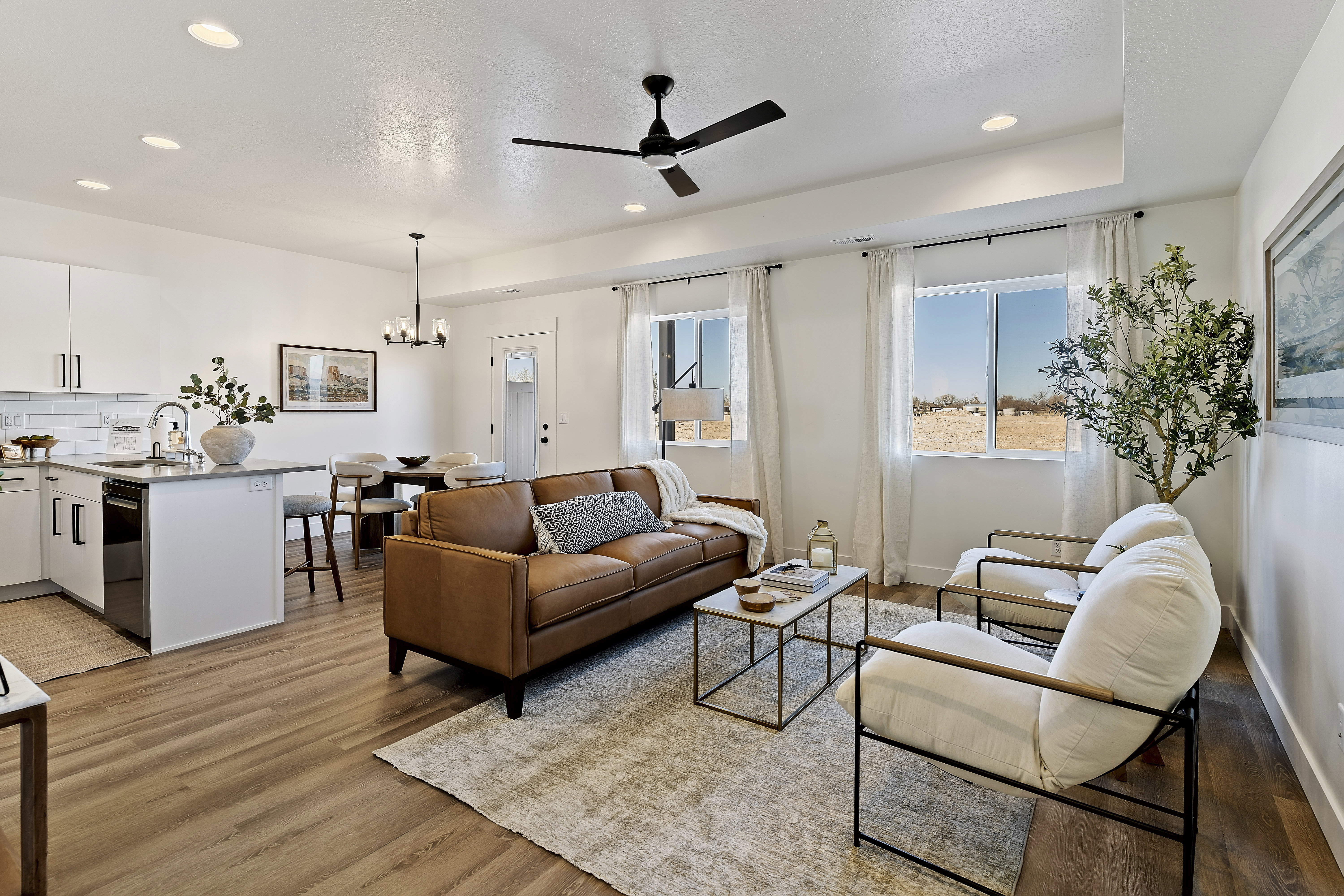 Open-concept living area featuring wood-finish flooring, recessed lighting, and a contemporary ceiling fan
