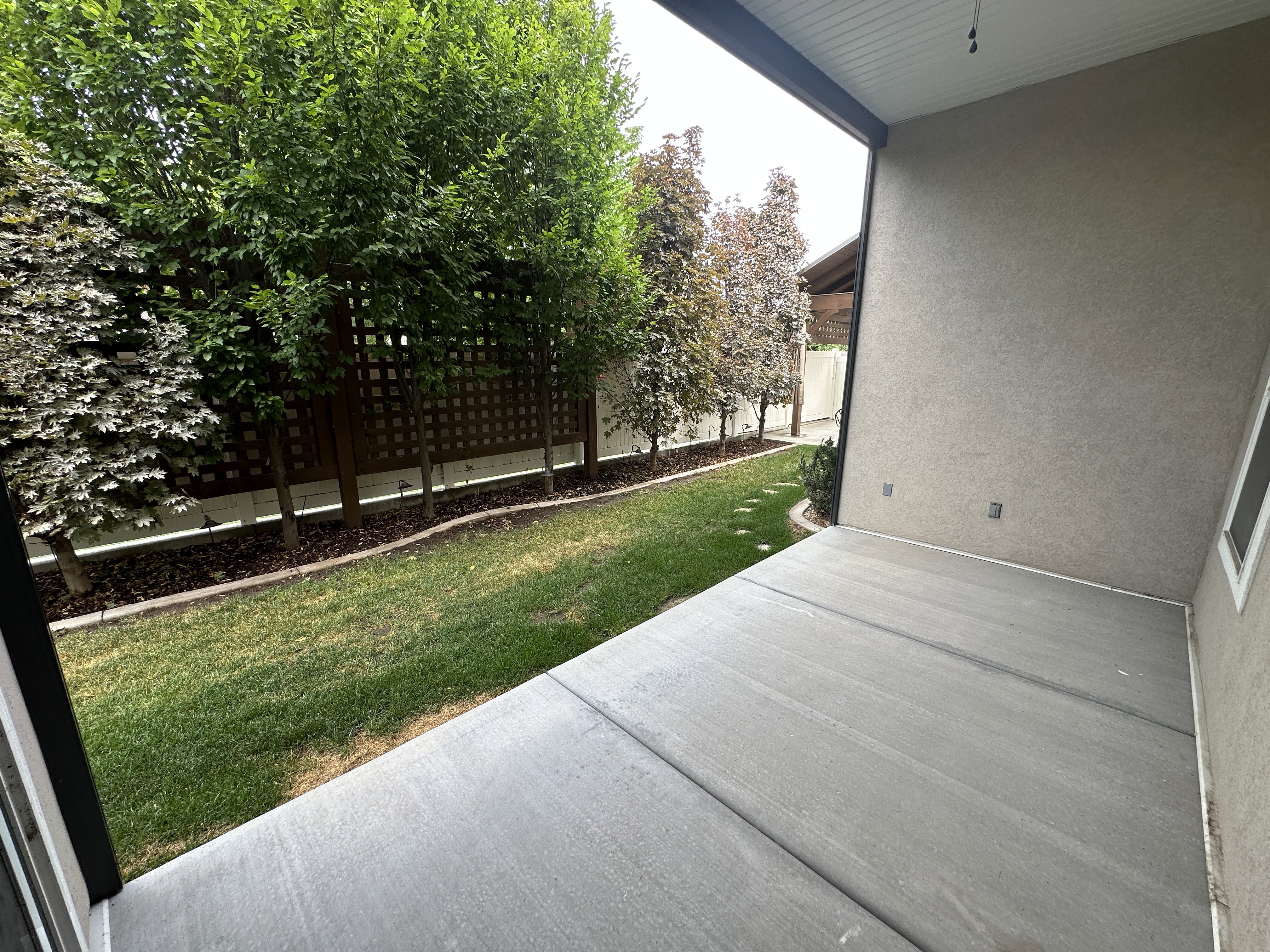 Covered patio with textured stucco siding