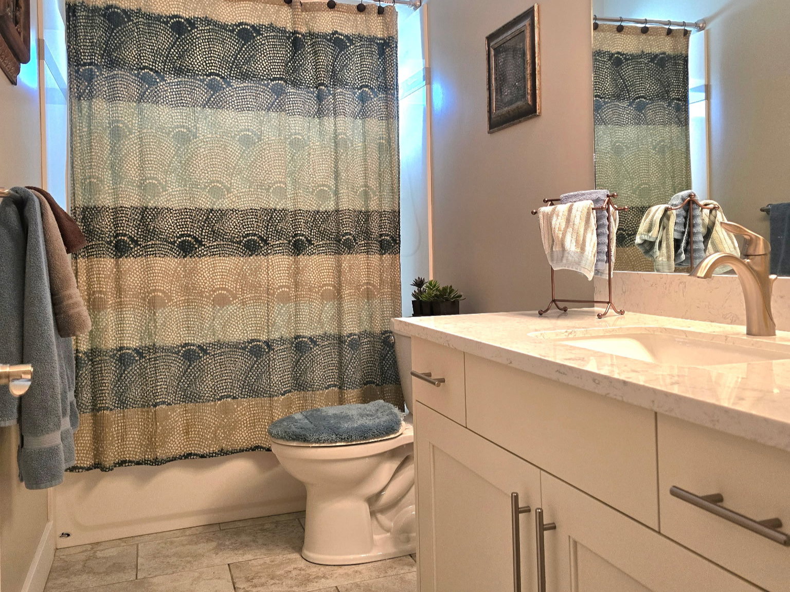 Bathroom featuring a single vanity with a light-colored countertop and under-sink storage