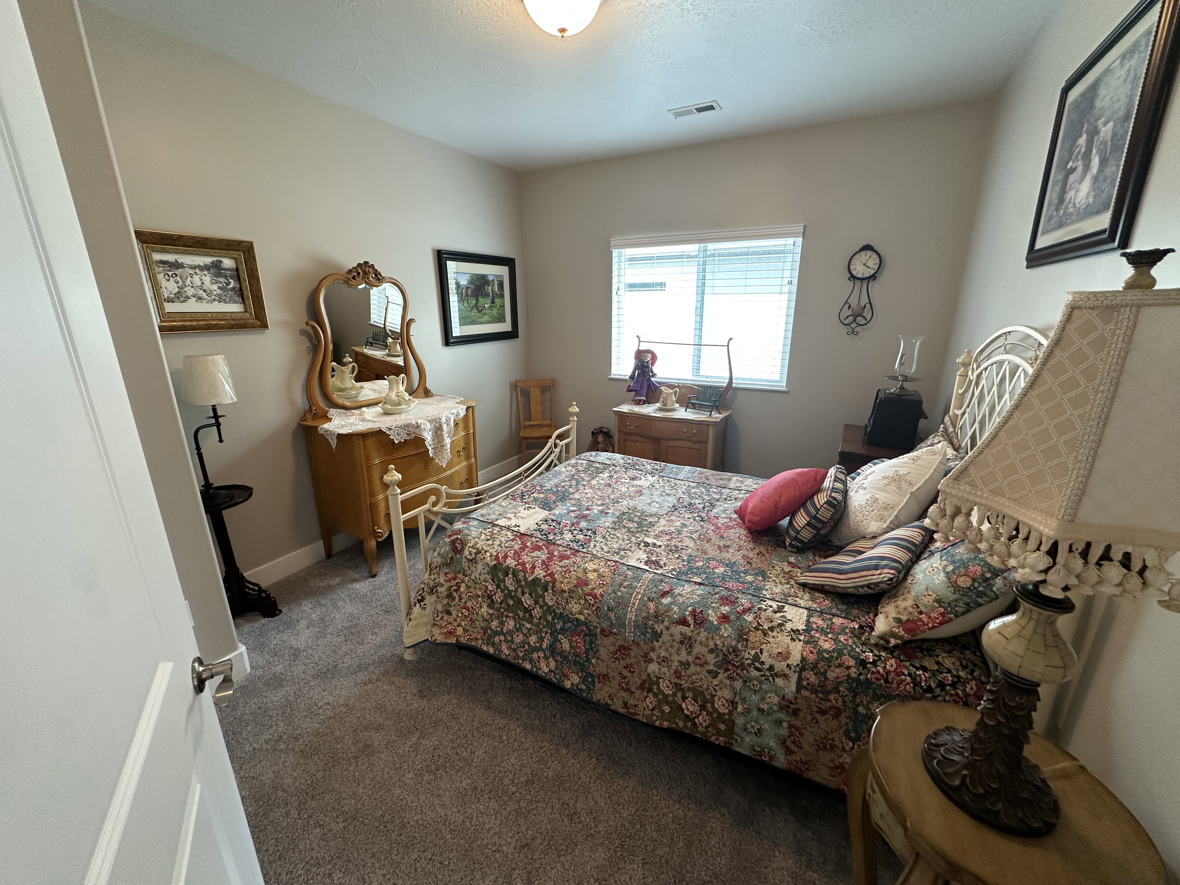 Carpeted room featuring a double-paned window with blinds, light gray wall paint, and a ceiling light fixture