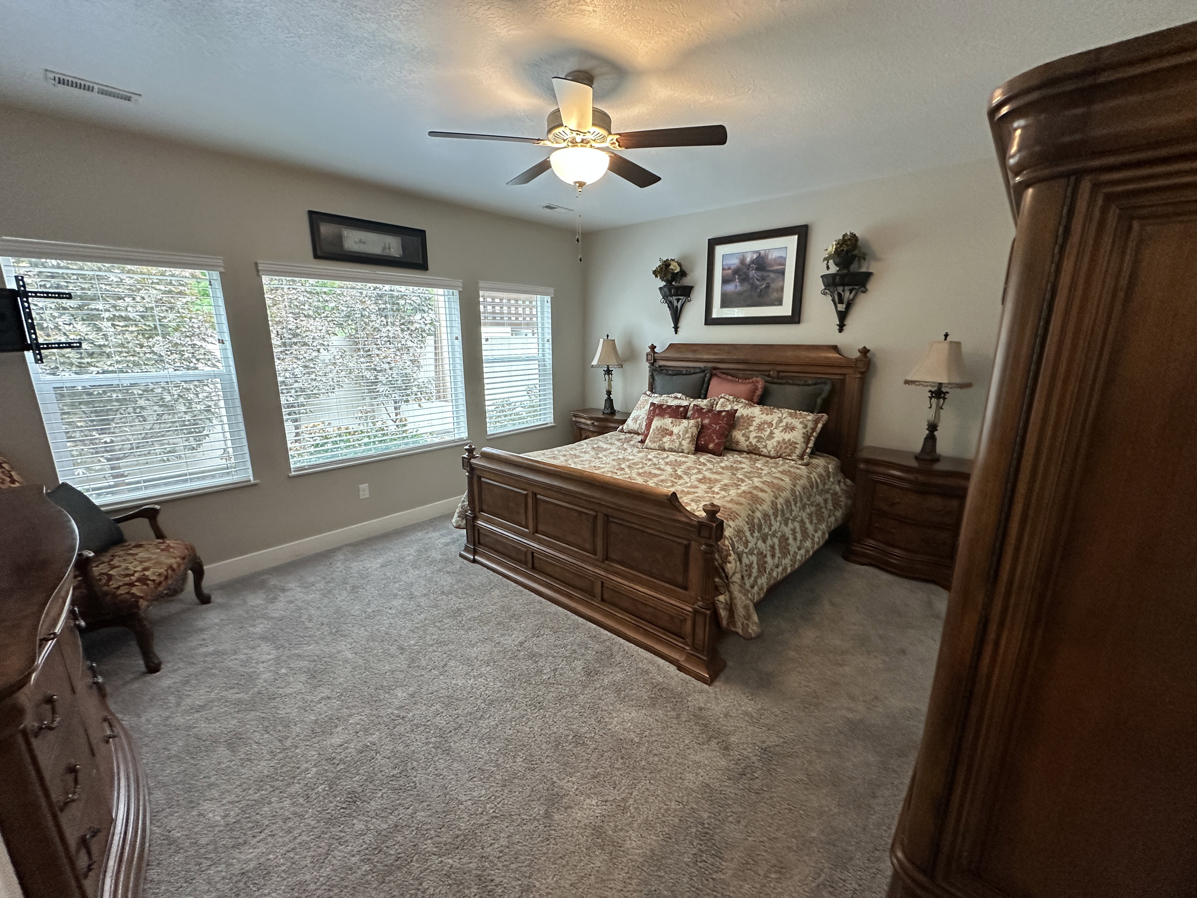 Spacious room featuring light gray carpeting and a neutral wall color