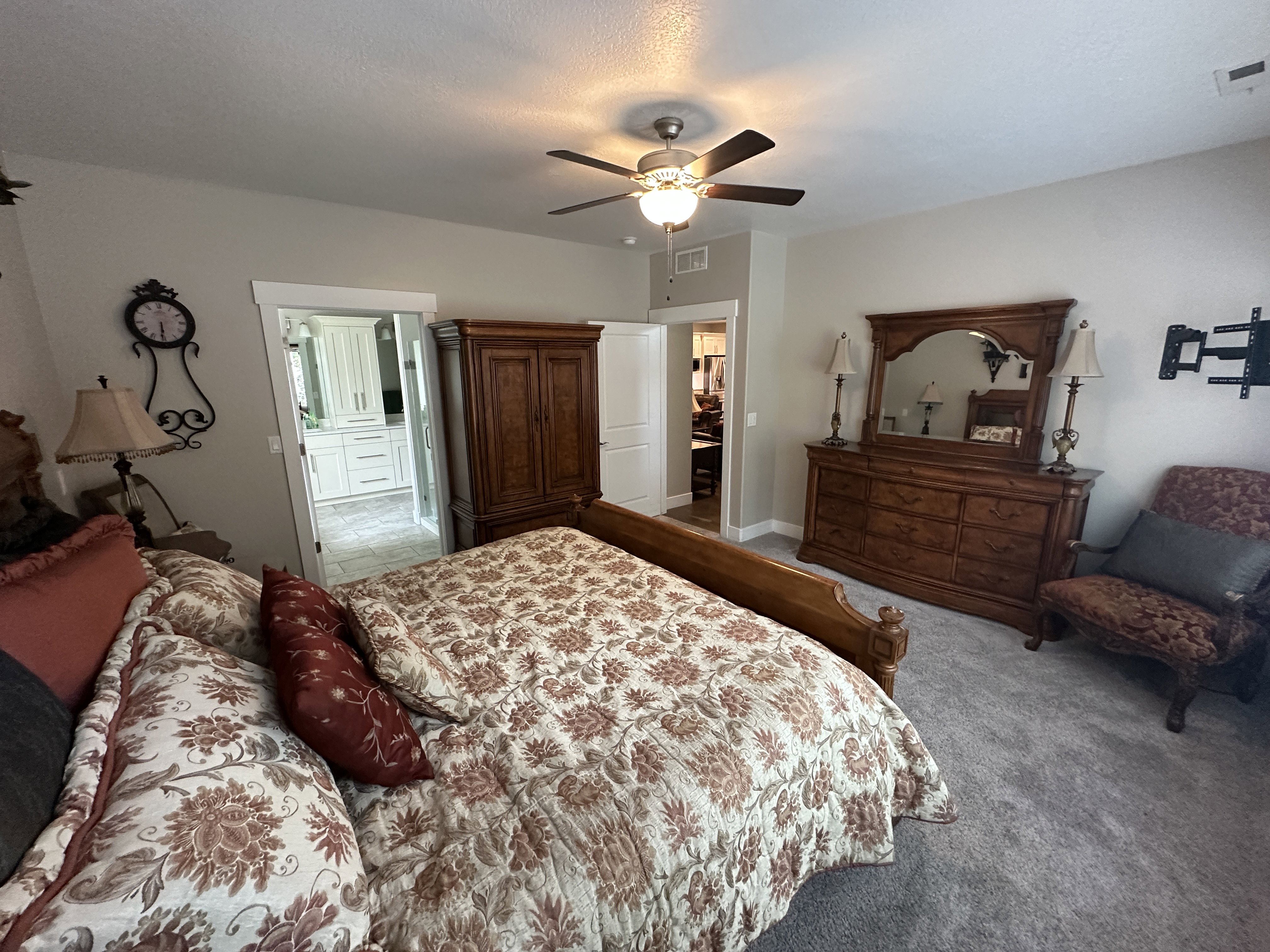 Spacious room featuring neutral carpeting and a ceiling fan with integrated lighting