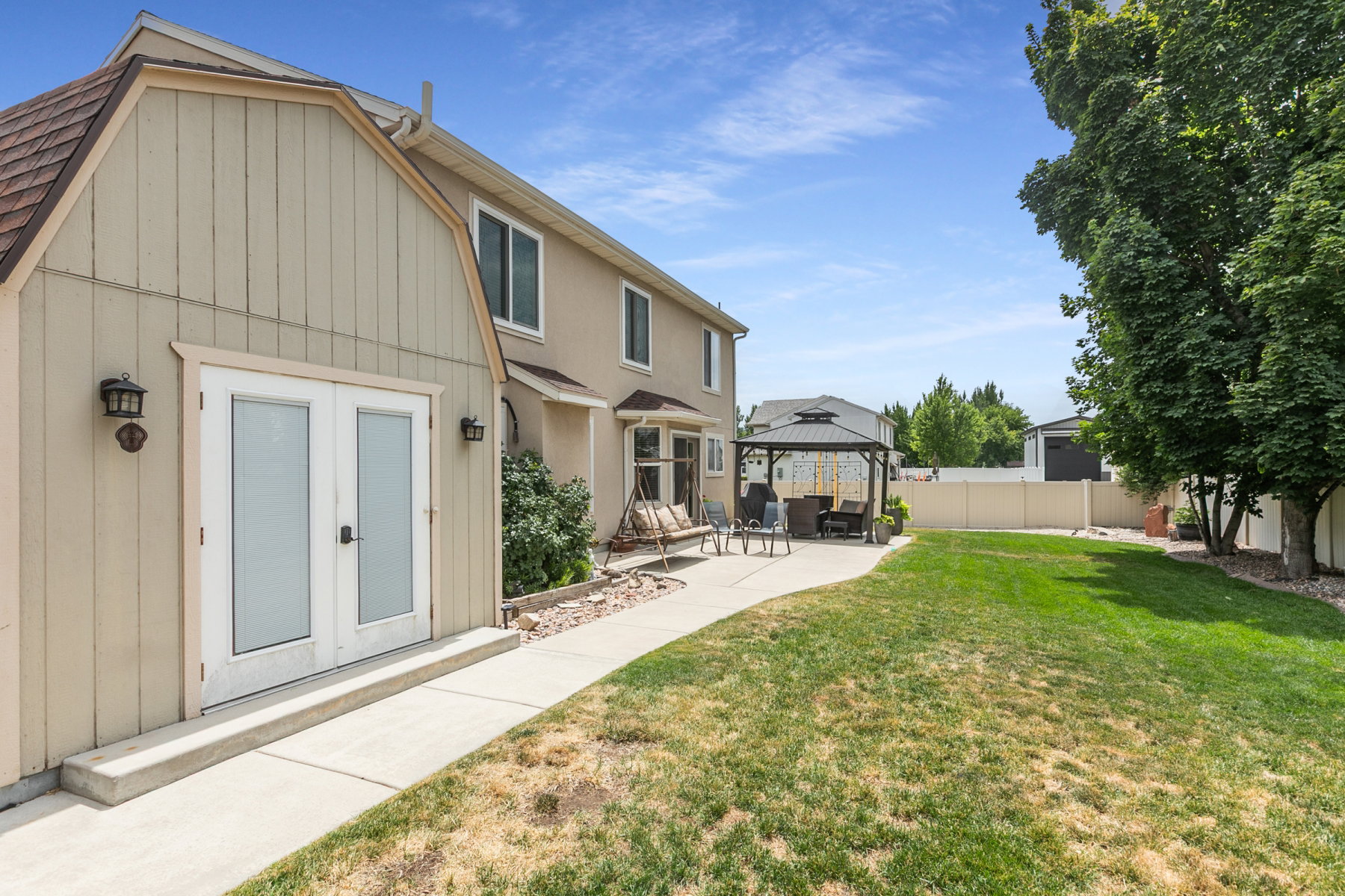 Bonus Room w/ separate entrance, featuring a large lawn, concrete patio, and a dedicated covered gazebo area